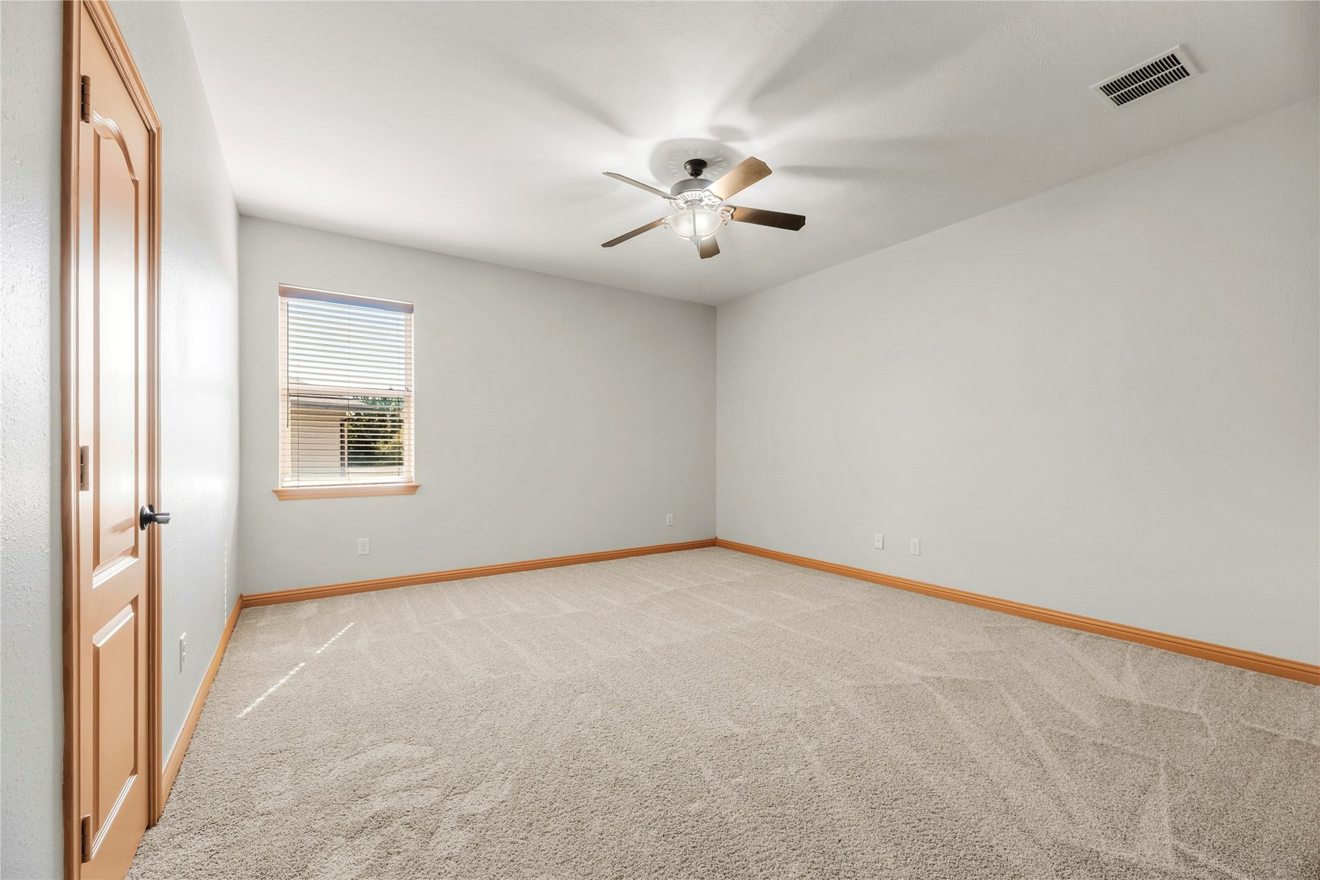 12002 Tall Haven Lane, Cypress, TX 77433 Spacious bedroom featuring a ceiling fan and a versatile layout.