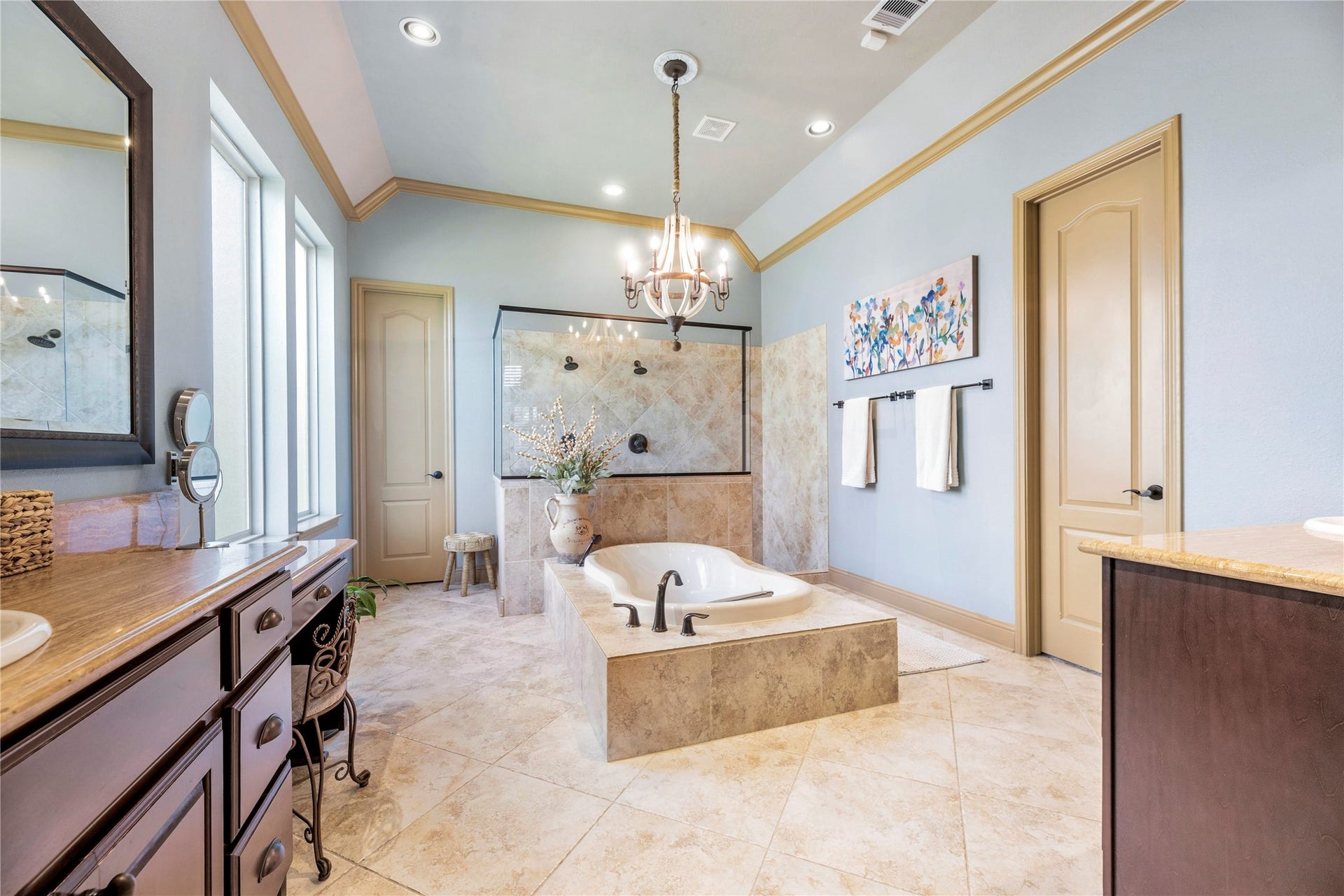 12002 Tall Haven Lane, Cypress, TX 77433 Luxurious primary bathroom featuring a spacious soaking tub, elegant finishes, and a beautiful chandelier.