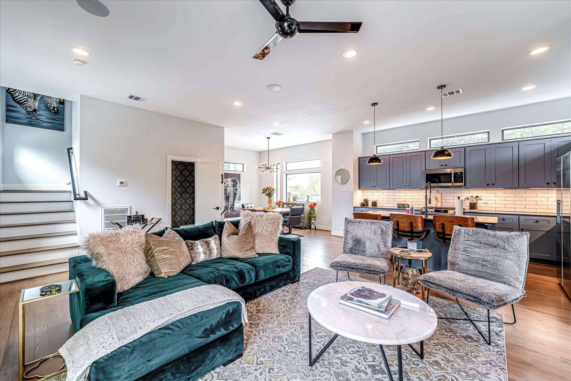 3514 Arlington Street, Houston, TX 77018 Bright open-concept living space with abundant natural light, designer finishes, and elegant hardwood floors throughout. Photos reflect previous furnishings. Home is currently vacant. Furnishings shown are for illustrative purposes only.