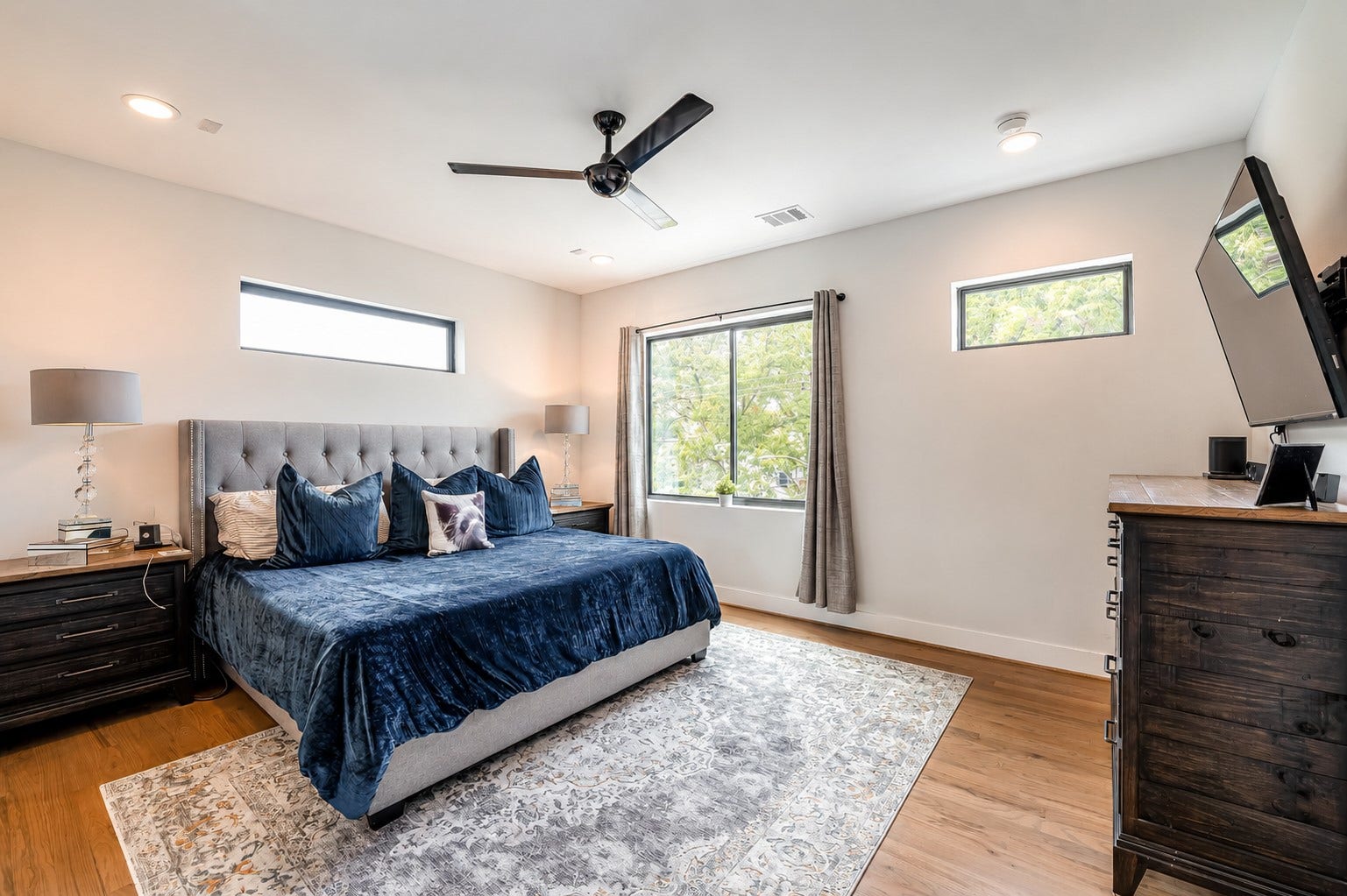 3514 Arlington Street, Houston, TX 77018 Spacious primary retreat with oversized dimensions, abundant natural light, and elegant hardwood flooring. Photos reflect previous furnishings. Home is currently vacant. Furnishings shown are for illustrative purposes only.
