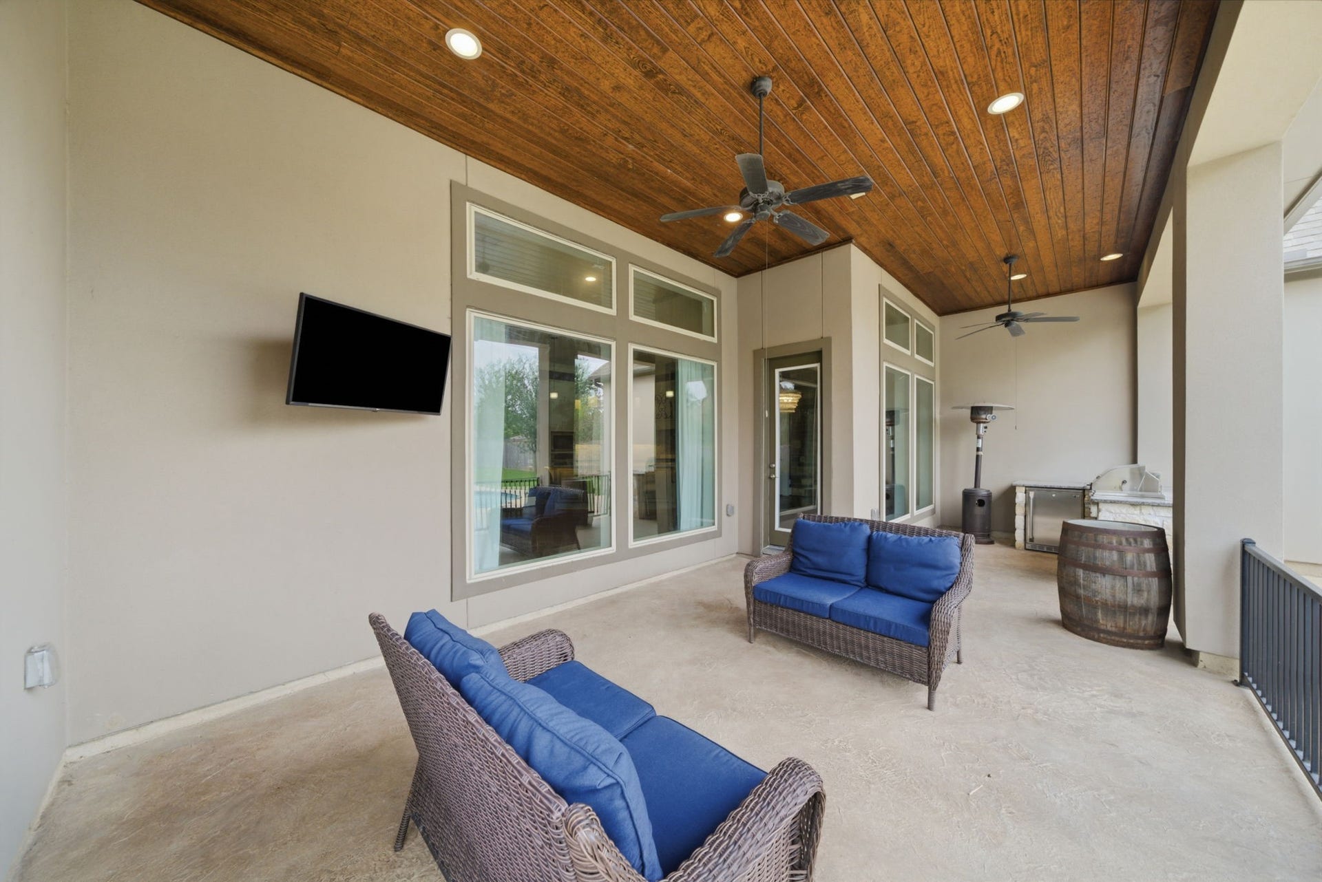 1510 Whispering Pines Drive, Houston, TX 77055 Covered patio with seating area and summer kitchen.