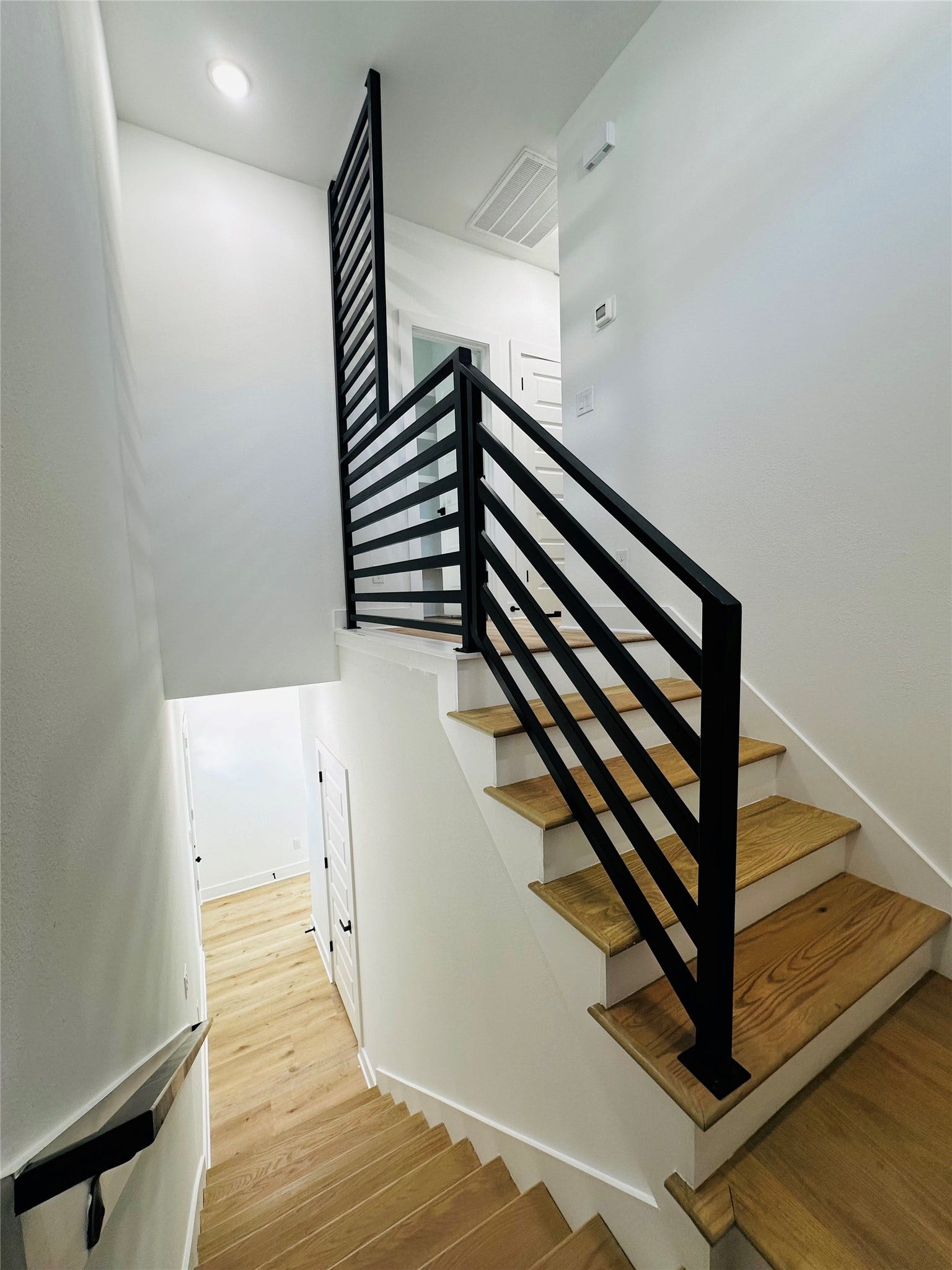 All stairs feature custom made wrought iron stai rails and ballusters