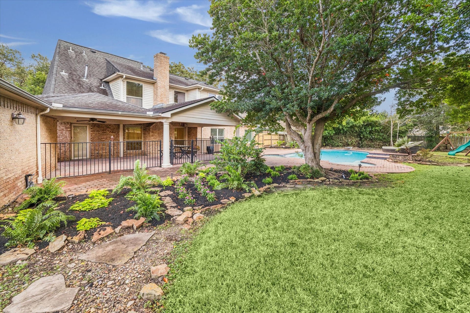 The beautifully upgraded landscape defines this backyard oasis.