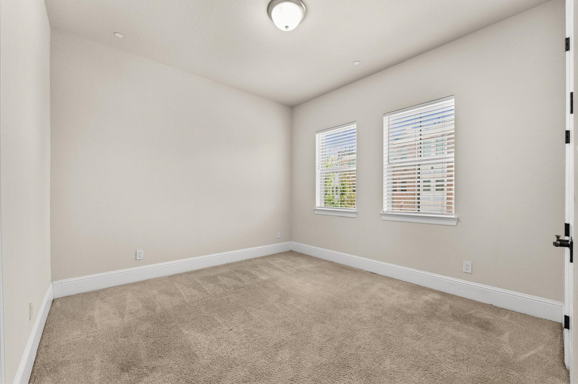 Bedroom 3 featuring updated carpeting.