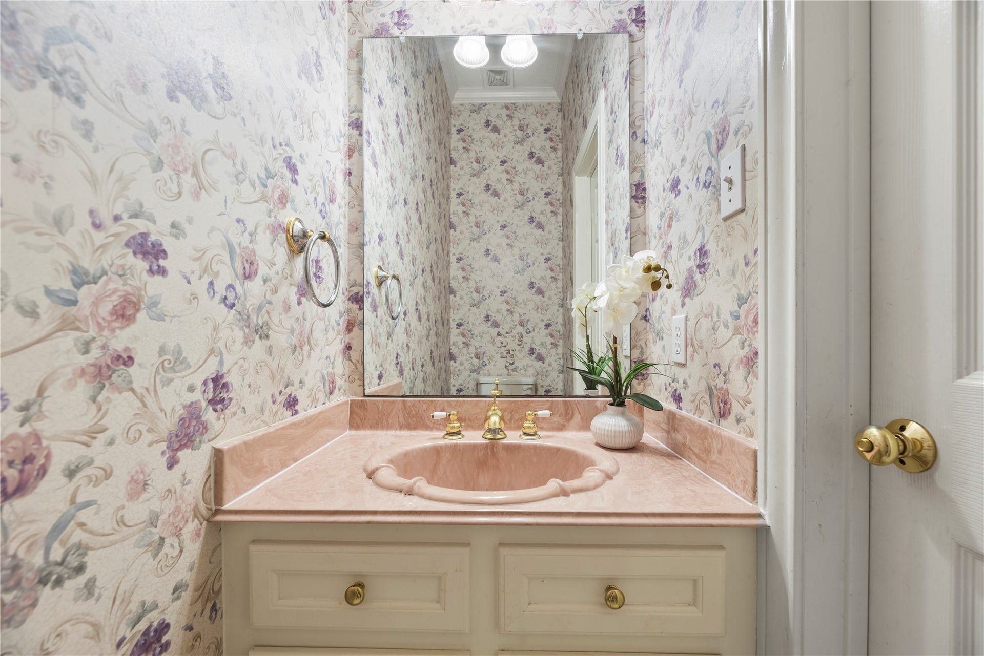 Conveniently located half bath offers added functionality for guests.