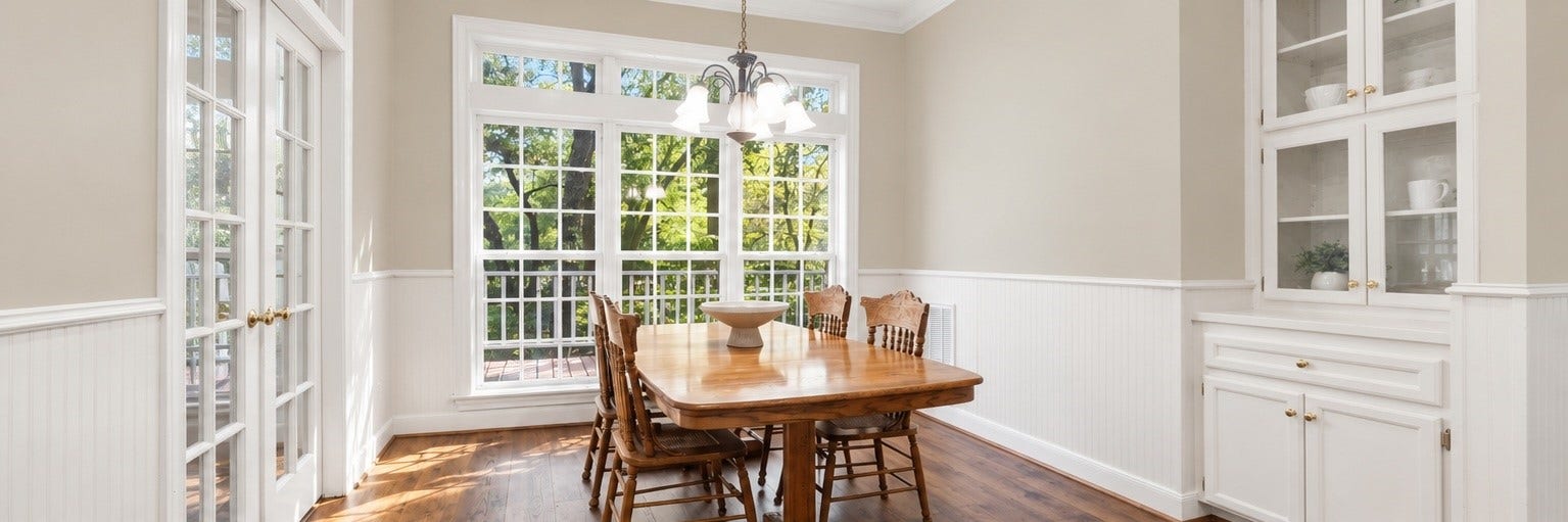 AI-generated visualization showing the dining area with the existing wallpaper removed and replaced with neutral paint. Provided for inspiration only; actual property currently has wallpaper.
