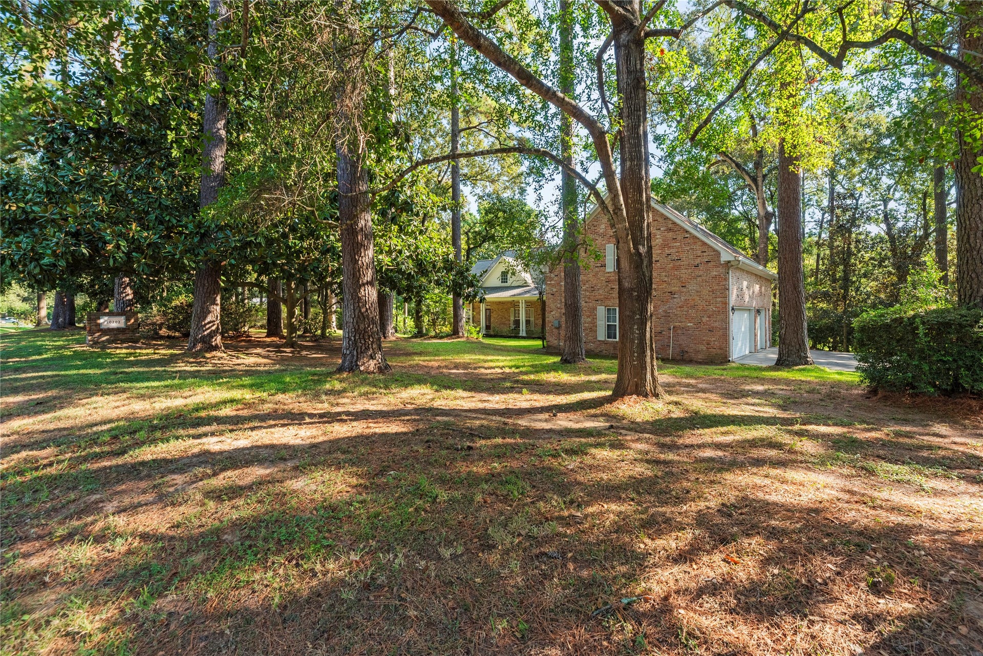 Mature trees and lush landscaping surround this beautiful property, offering a peaceful, park-like setting. The detached garage provides additional parking and nearly 1,000 SF of flexible living space above.