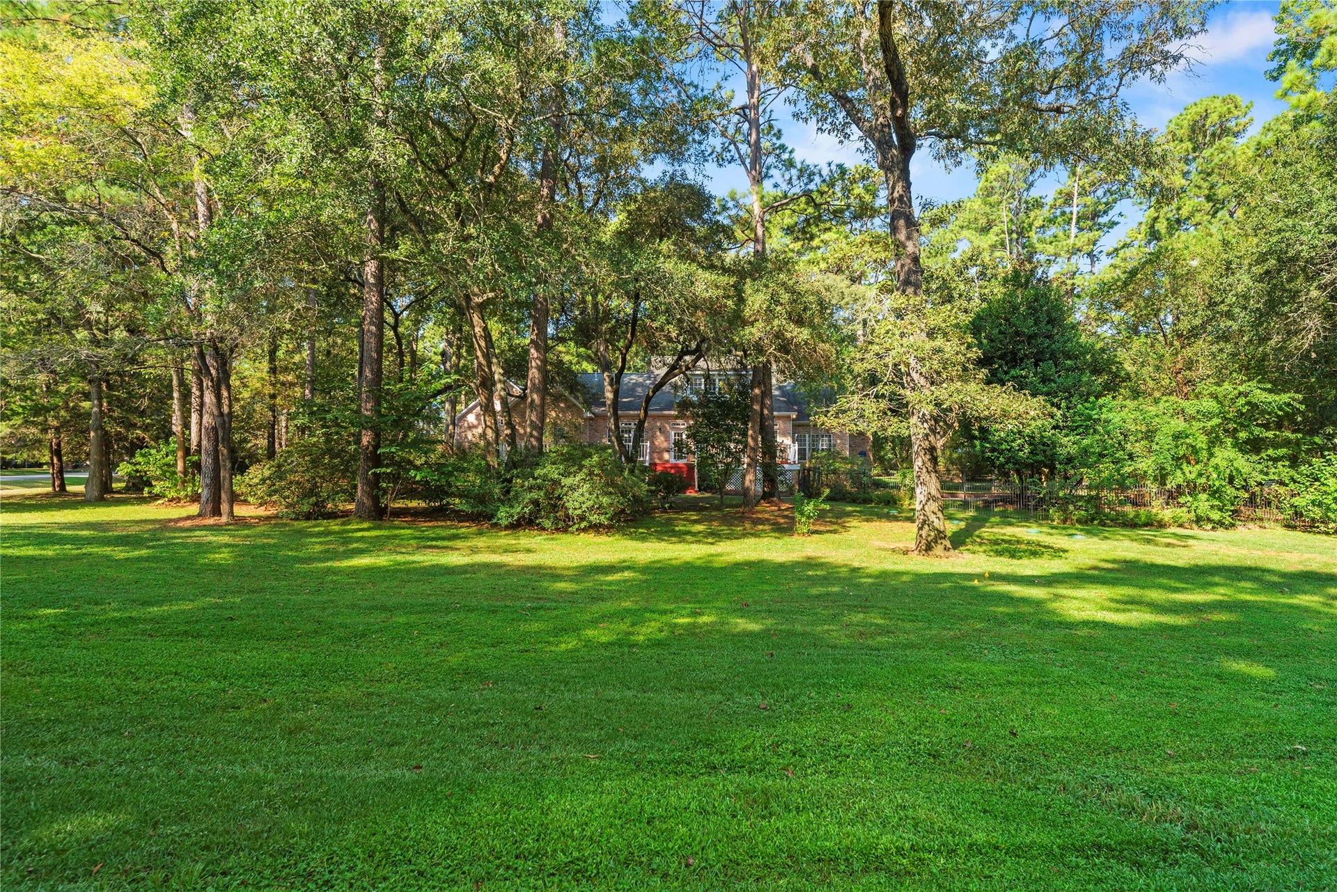 The adjoining second lot adds approximately one acre of open, wooded space, bringing the property to nearly 2 acres total with plenty of room to enjoy, play, garden, or simply spread out.