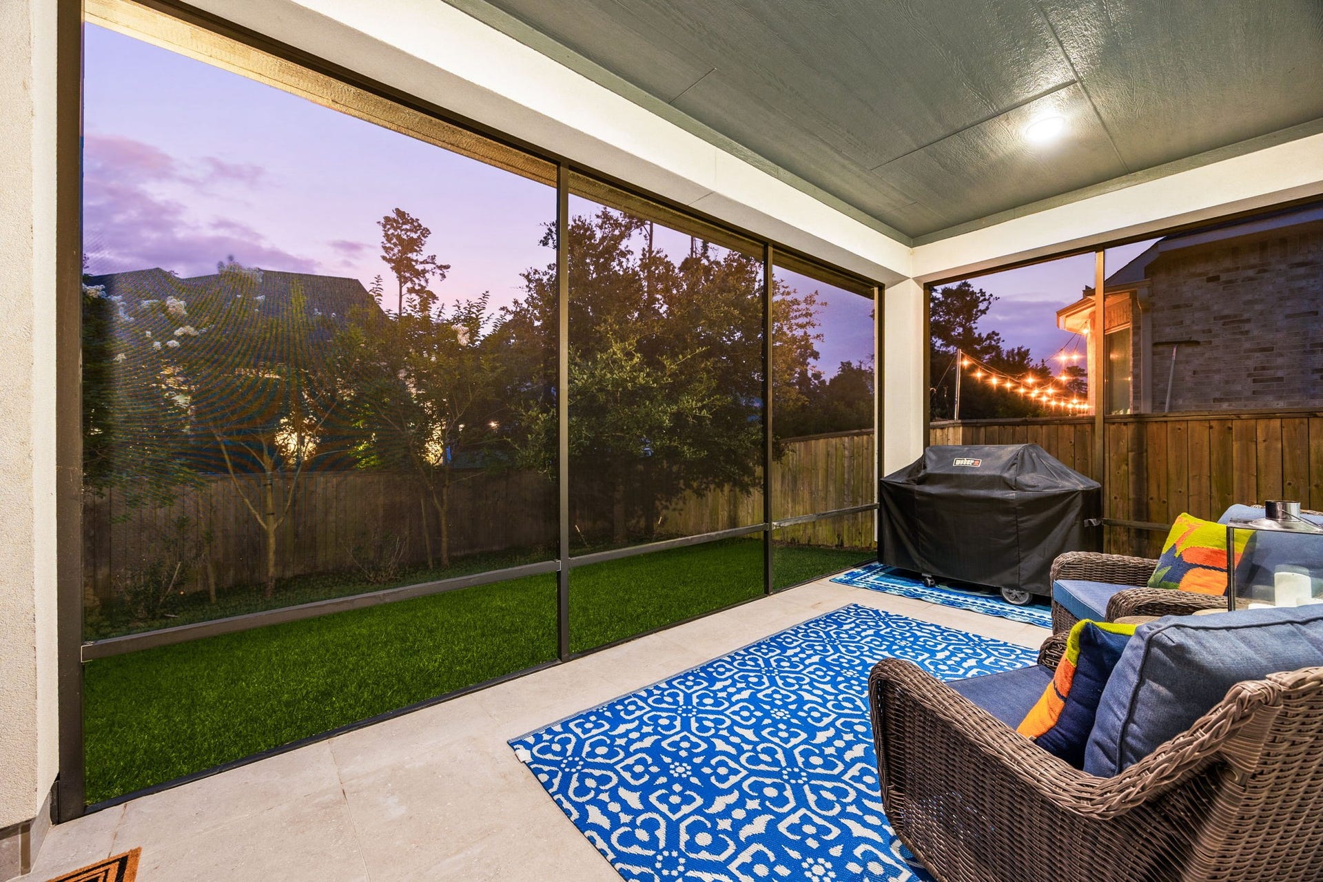 18 Gentle Branch Place, The Woodlands, TX 77375 Enjoy year-round outdoor living on this incredible covered patio, featuring motorized retractable screens for ultimate comfort and privacy. Overlooking a sparkling pool and low-maintenance turf lawn, this sophisticated space is the perfect retreat for dining alfresco or relaxing in the evening breeze.