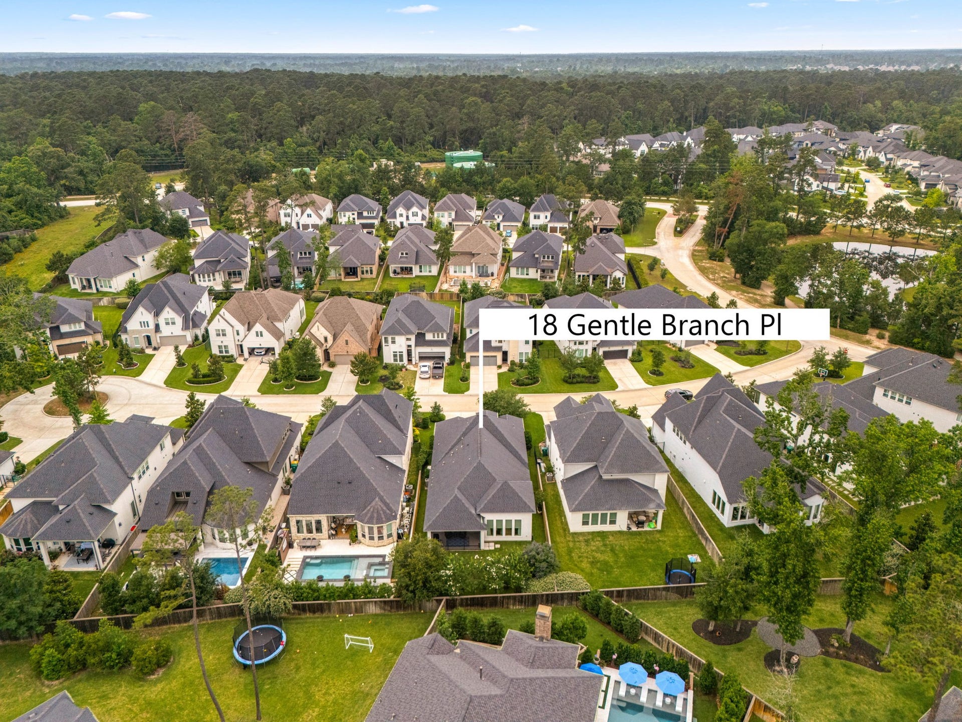18 Gentle Branch Place, The Woodlands, TX 77375 Located in the highly sought-after Creekside Park West, this modern gem is perfectly positioned within a vibrant, amenity-rich community. The aerial perspective highlights the home's contemporary architecture and its prime location just minutes from top-rated schools, parks, and world-class shopping and dining.
