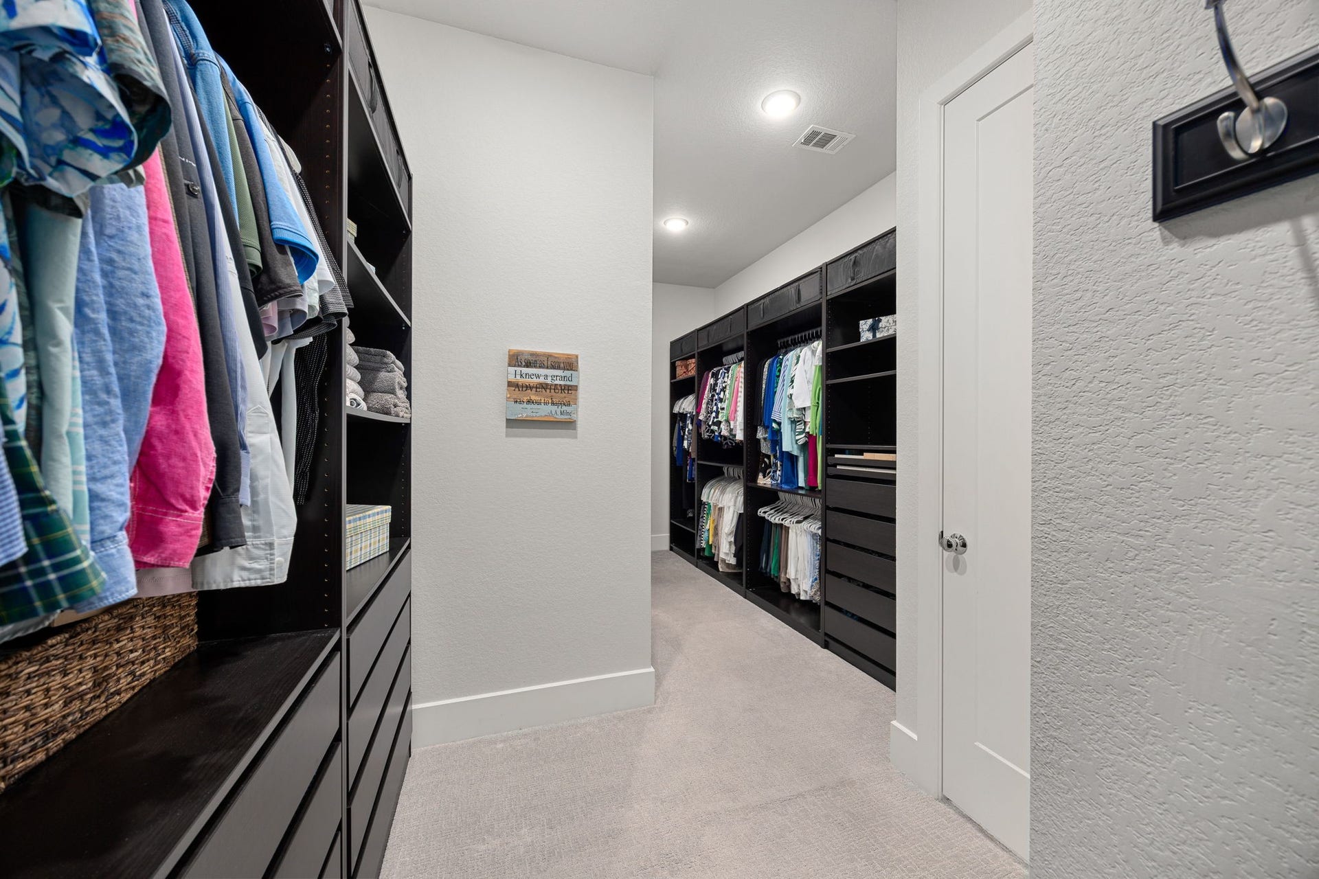 18 Gentle Branch Place, The Woodlands, TX 77375 Organization meets luxury in this massive primary walk-in closet. Featuring extensive custom-built shelving, ample hanging space, and integrated dresser drawers, this bright and thoughtfully designed space offers unparalleled storage and functionality.