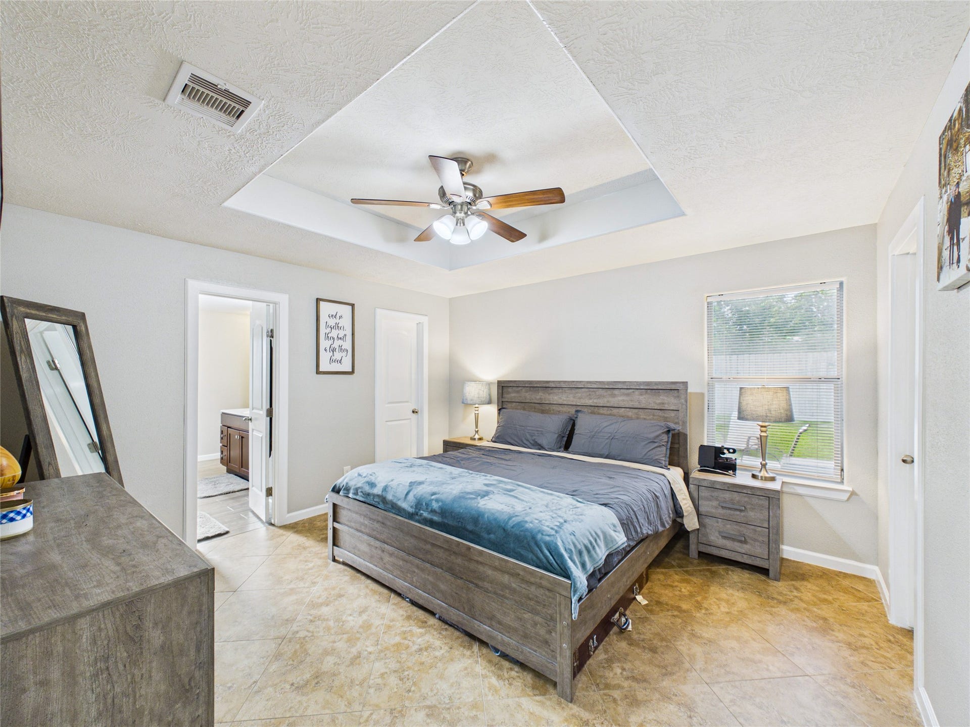 9022 Barracuda Drive, Texas City, TX 77591 Beautiful primary bedroom with a stunning tray ceiling and spacious his-and-hers walk-in closets.