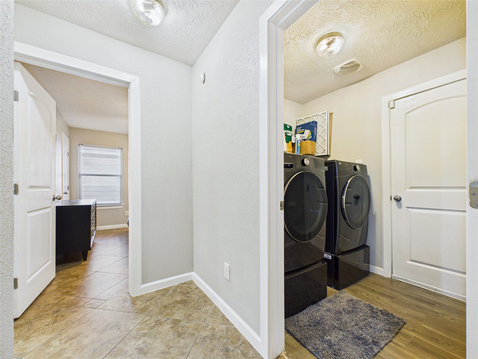 9022 Barracuda Drive, Texas City, TX 77591 Laundry room and a welcoming hallway leading to bedrooms. Tile flooring and fresh paint continued throughout.