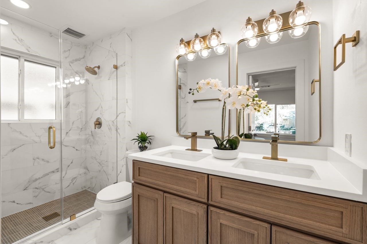 5207 Hummingbird Street, Houston, TX 77035 Updated primary bath with double vanity, glass-enclosed walk-in shower, marble-look tile and modern finished