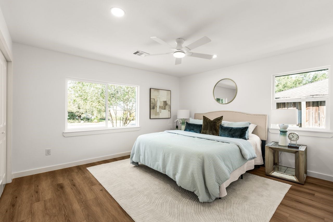 5207 Hummingbird Street, Houston, TX 77035 Spacious primary bedroom with multiple windows, ceiling fan and warm luxury vinyl plank flooring
