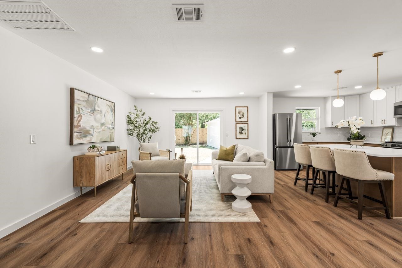 5207 Hummingbird Street, Houston, TX 77035 Spacious living area with abundant natural light and sliding doors overlooking the fenced backyard
