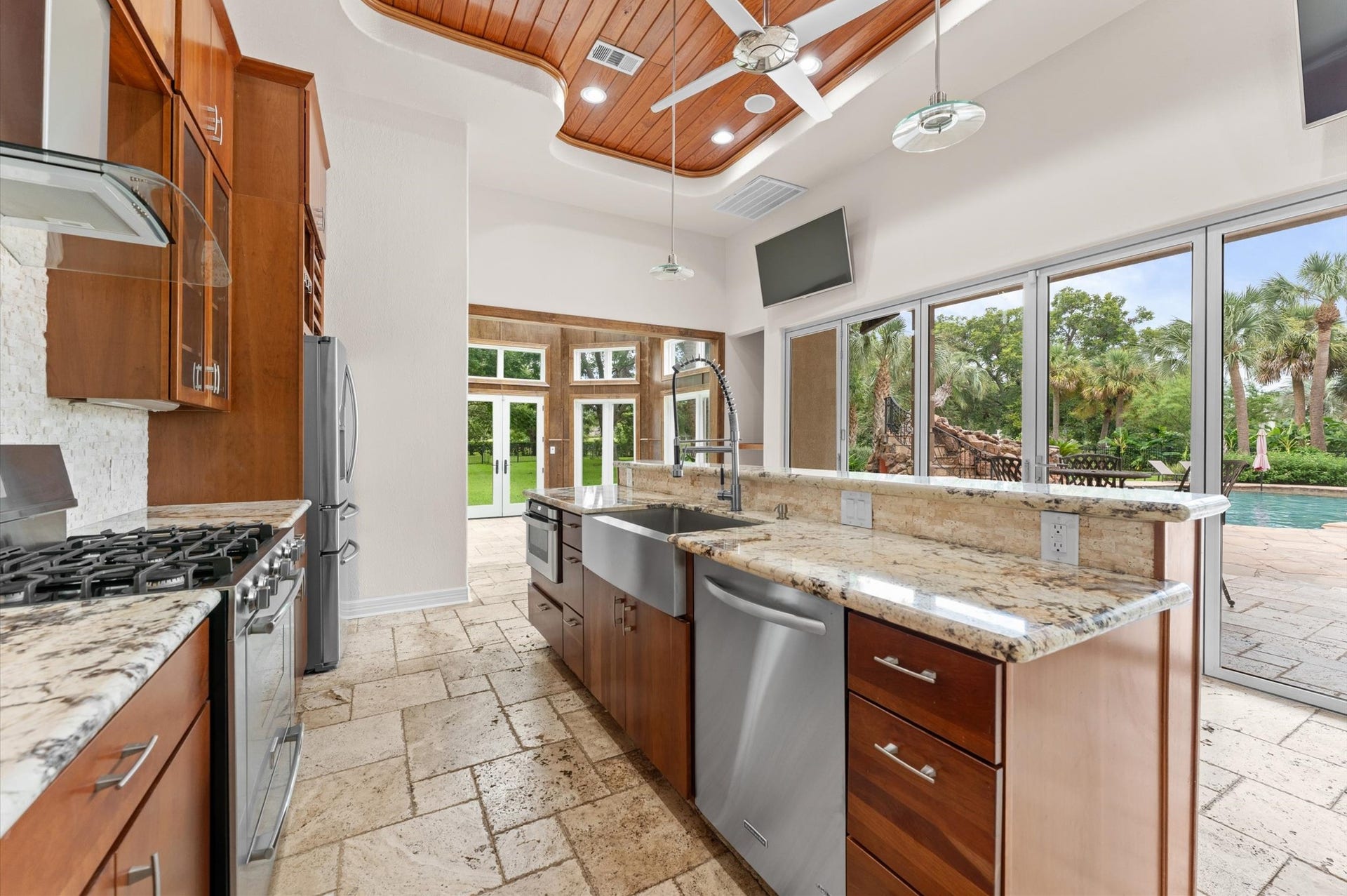 1830 Forest Gate Circle, Sugar Land, TX 77479 The cabana has a gourmet kitchen, gorgeous finishes, upgraded granite, tongue & groove wood ceiling, custom bifold sliding doors, full bathroom and travertine floors.