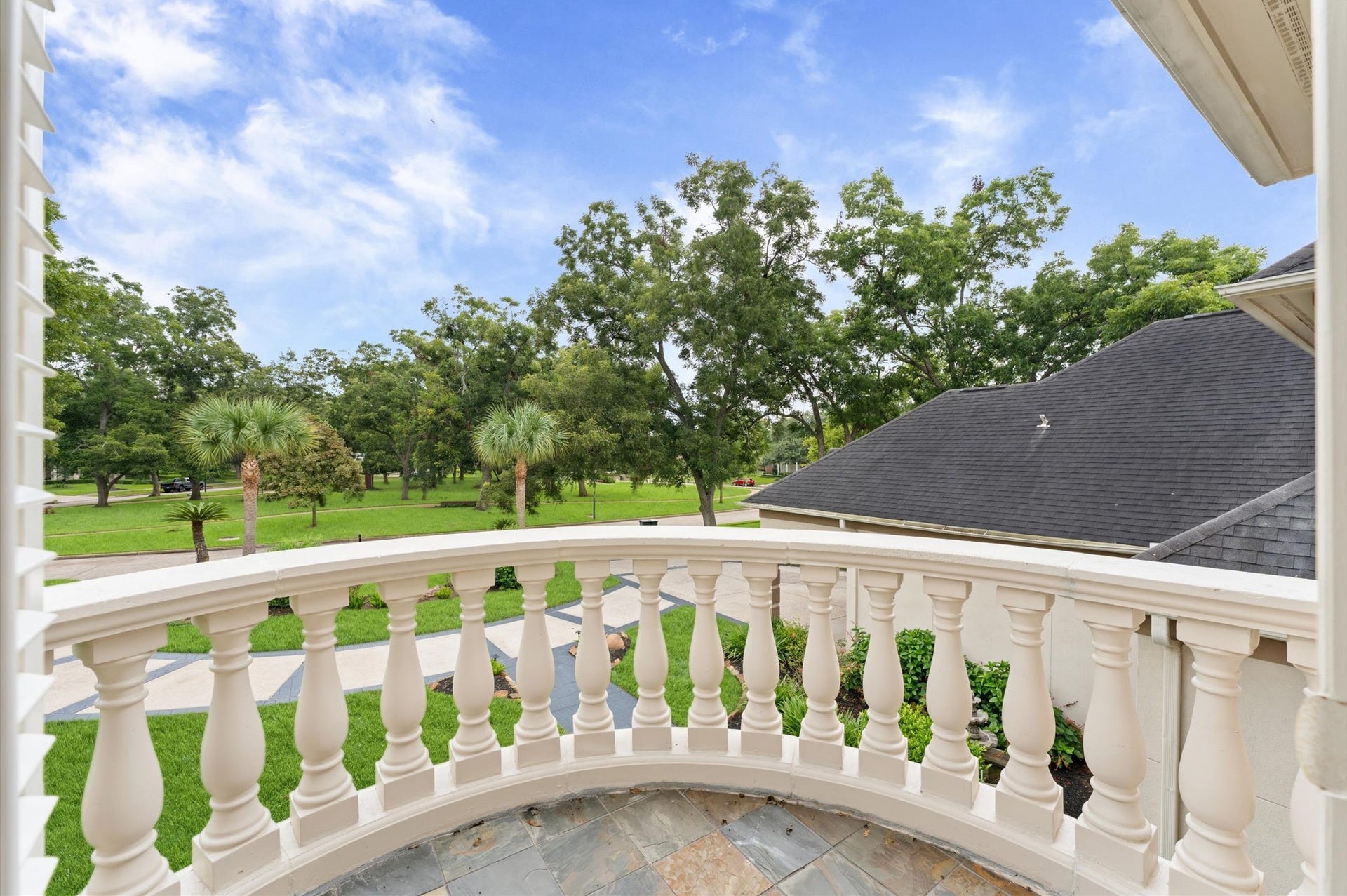 1830 Forest Gate Circle, Sugar Land, TX 77479 The upstairs balcony overlooks the tree-shaded park in front of the house.