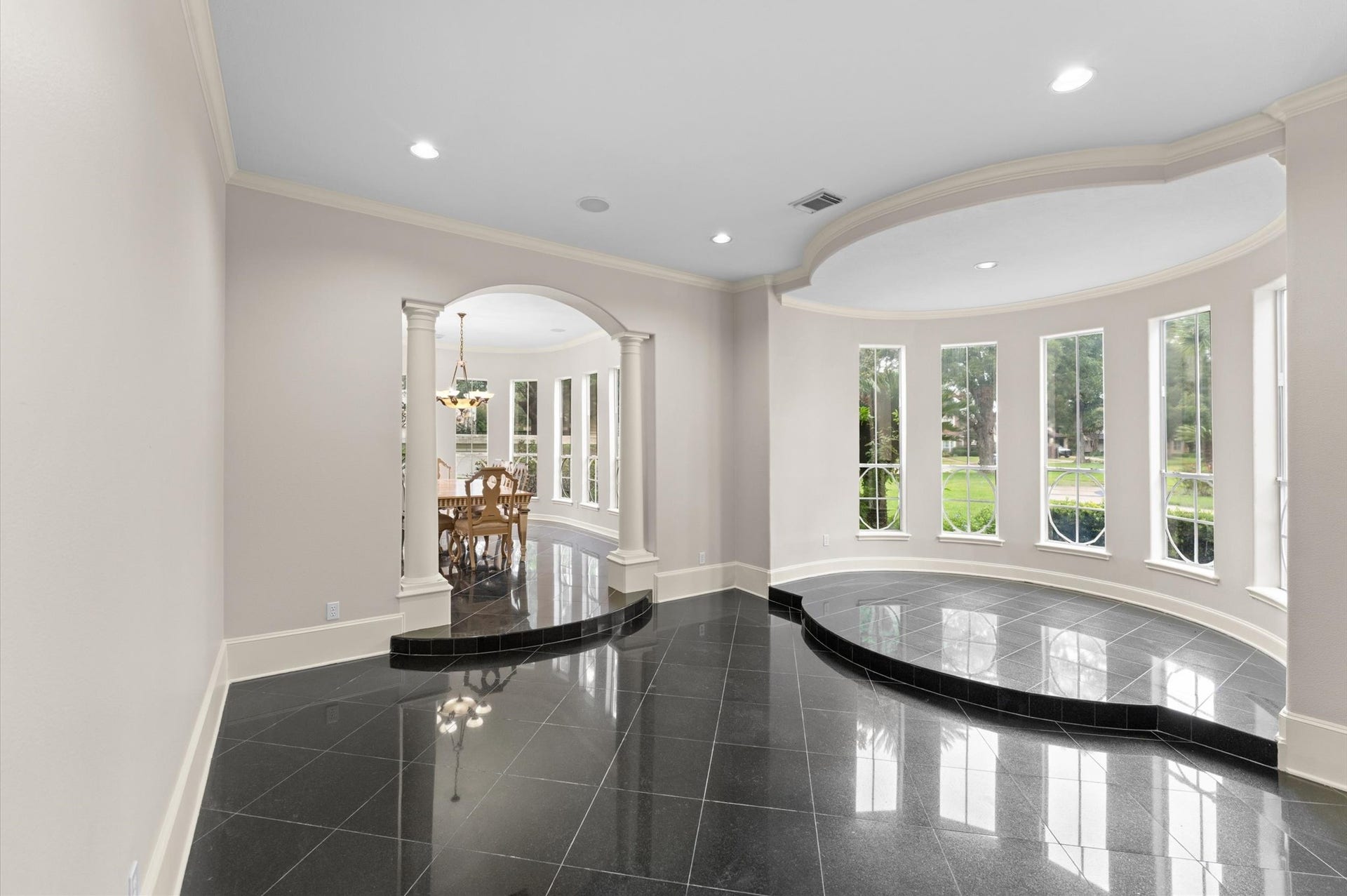 1830 Forest Gate Circle, Sugar Land, TX 77479 A view into the formal living room has a perfect spot for your baby grand by the wall of windows.