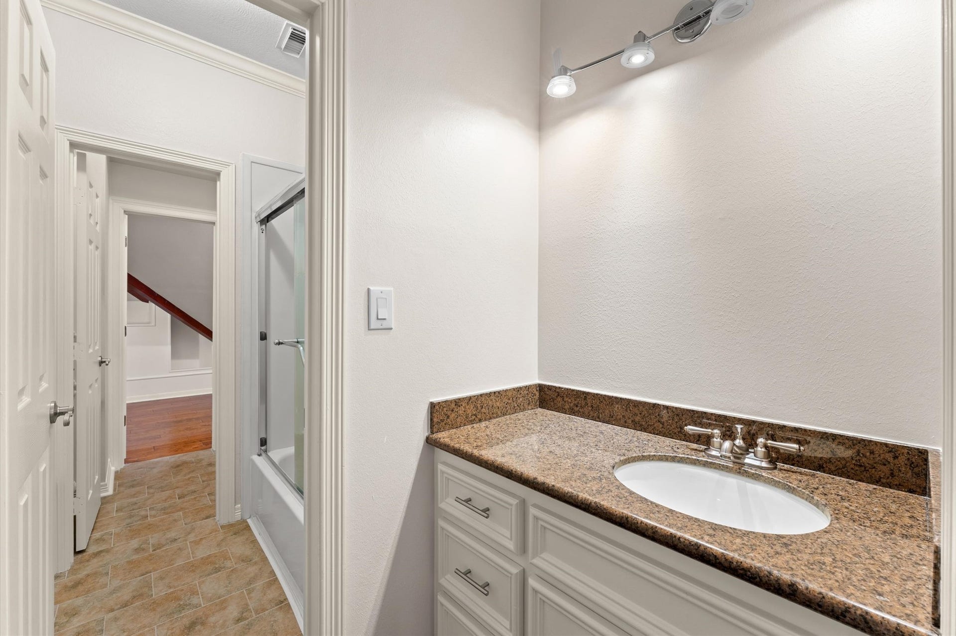 1830 Forest Gate Circle, Sugar Land, TX 77479 This bathroom has a separate door for the tub/shower and one for the toilet. It also leads into a huge climate-controlled storage area that has a spiral staircase to the garage and a hand sink.