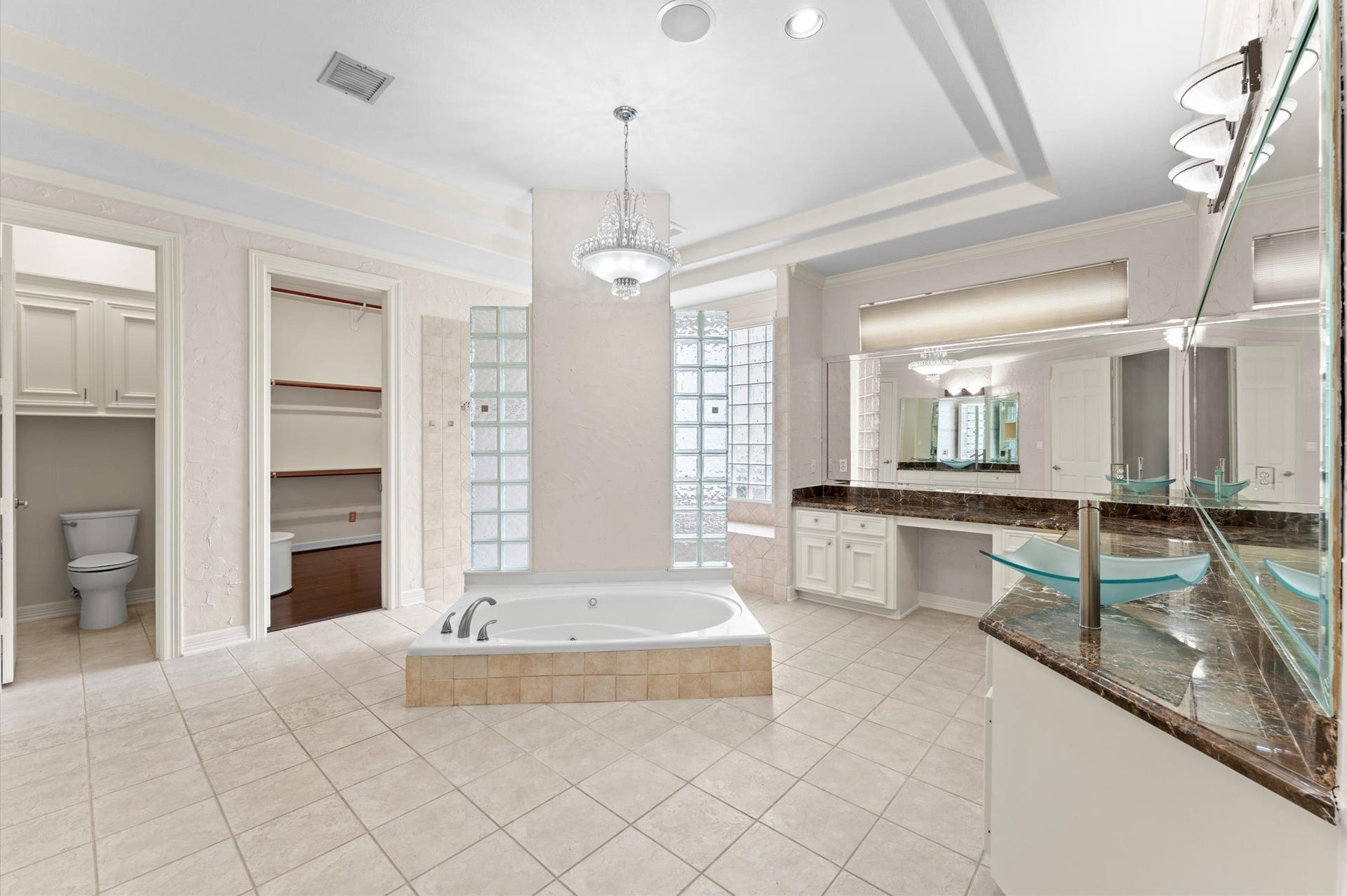 1830 Forest Gate Circle, Sugar Land, TX 77479 The primary bathroom has jetted tub, walk-through shower, double vanity, ample storage, private toilet closet with two walk-in closets.