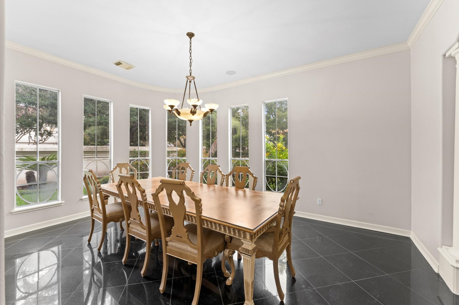 1830 Forest Gate Circle, Sugar Land, TX 77479 The dining room is highlighted by the custom windows, crown-molding and gorgeous chandelier adds ambience.