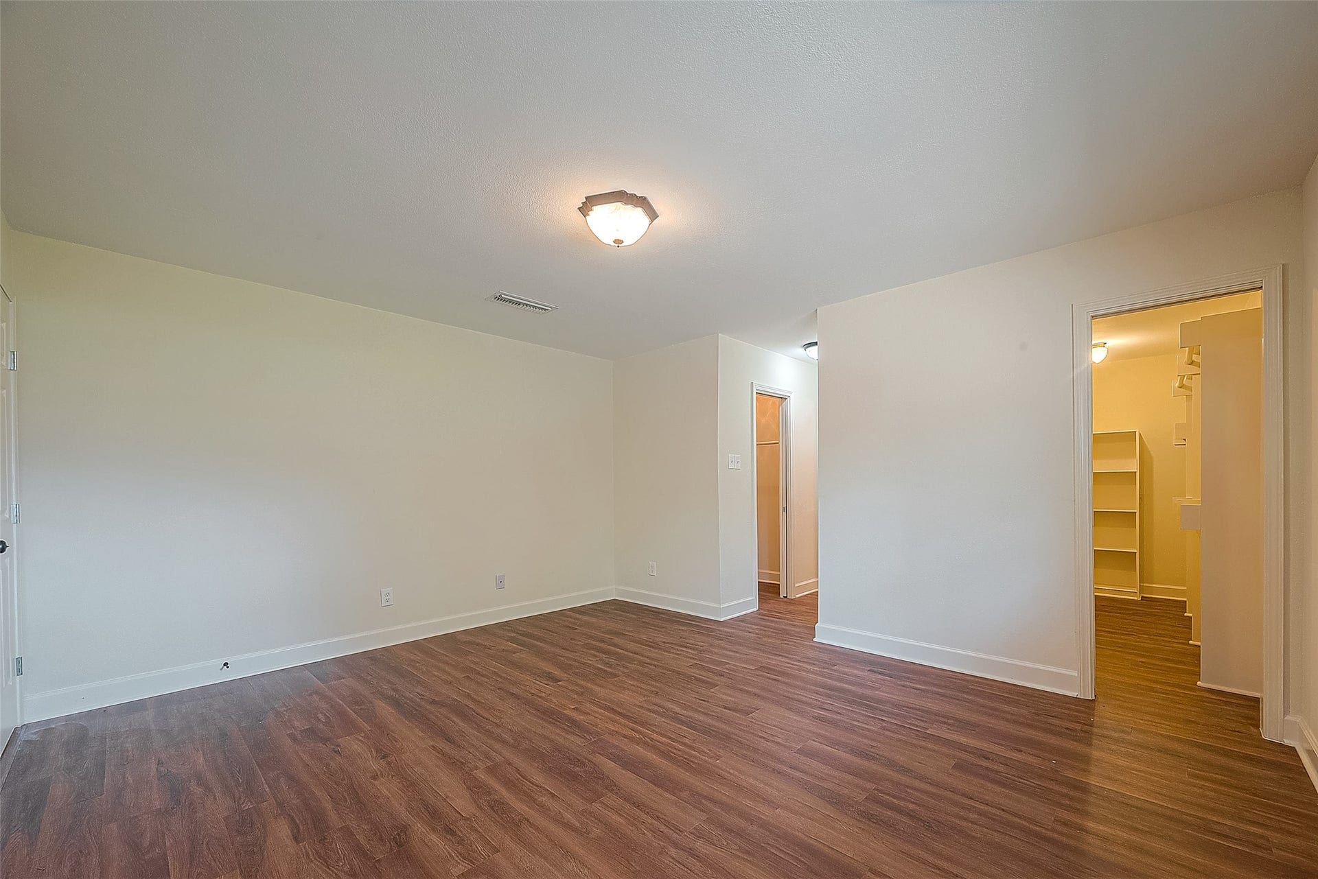 20 Champions Colony E, Houston, TX 77069 A view of the walk-in closet and primary bathroom from the primary bedroom.