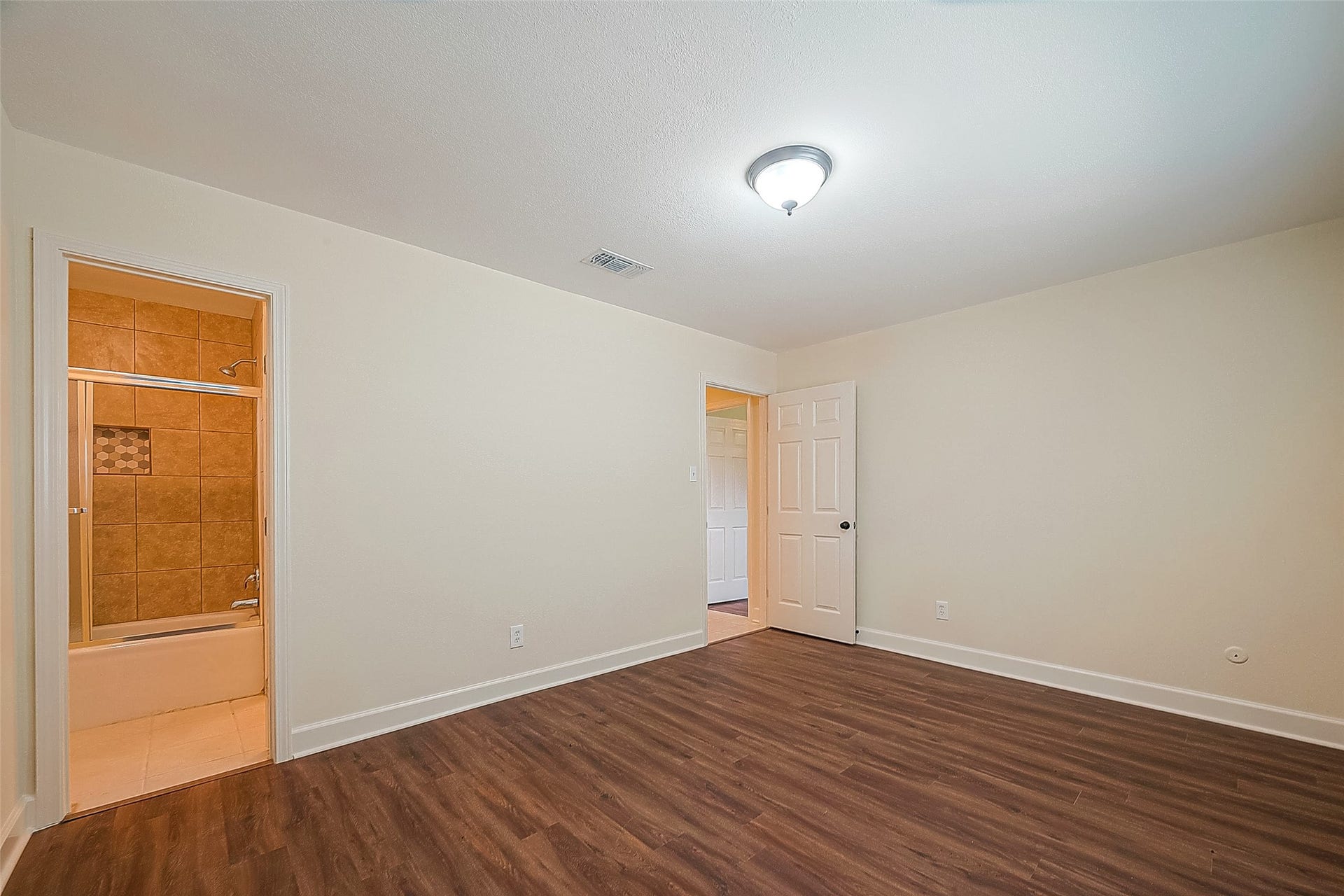 20 Champions Colony E, Houston, TX 77069 The second bedroom is a comfortable retreat, ideal for guests or as a home office, offering flexibility and privacy within the home.