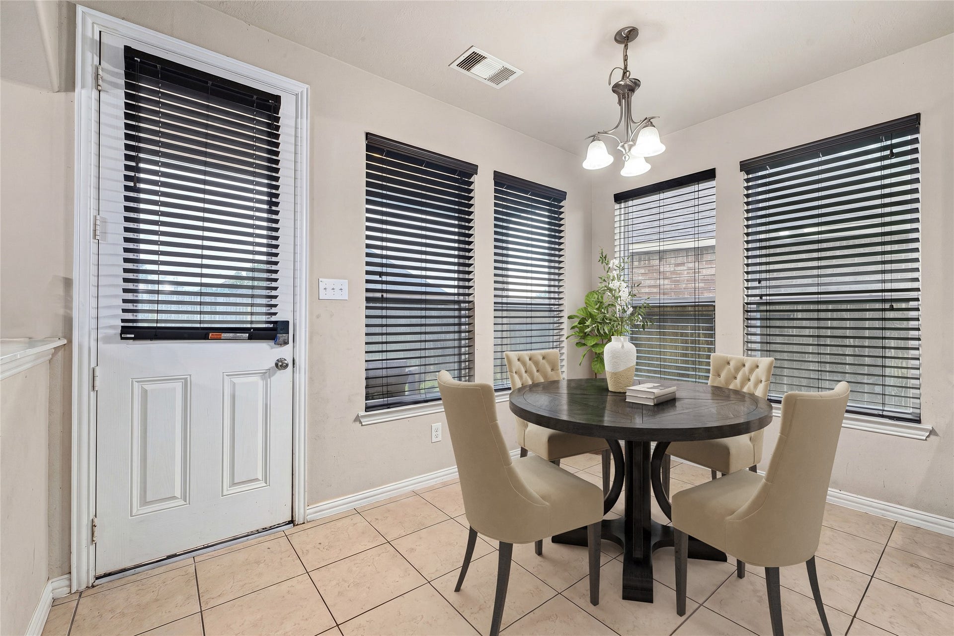7018 Pearl Terrace Lane, Richmond, TX 77469 Sunny breakfast area framed by a wall of windows, with direct access to the backyard through the exterior door, the perfect spot to start your day. *Virtually Staged