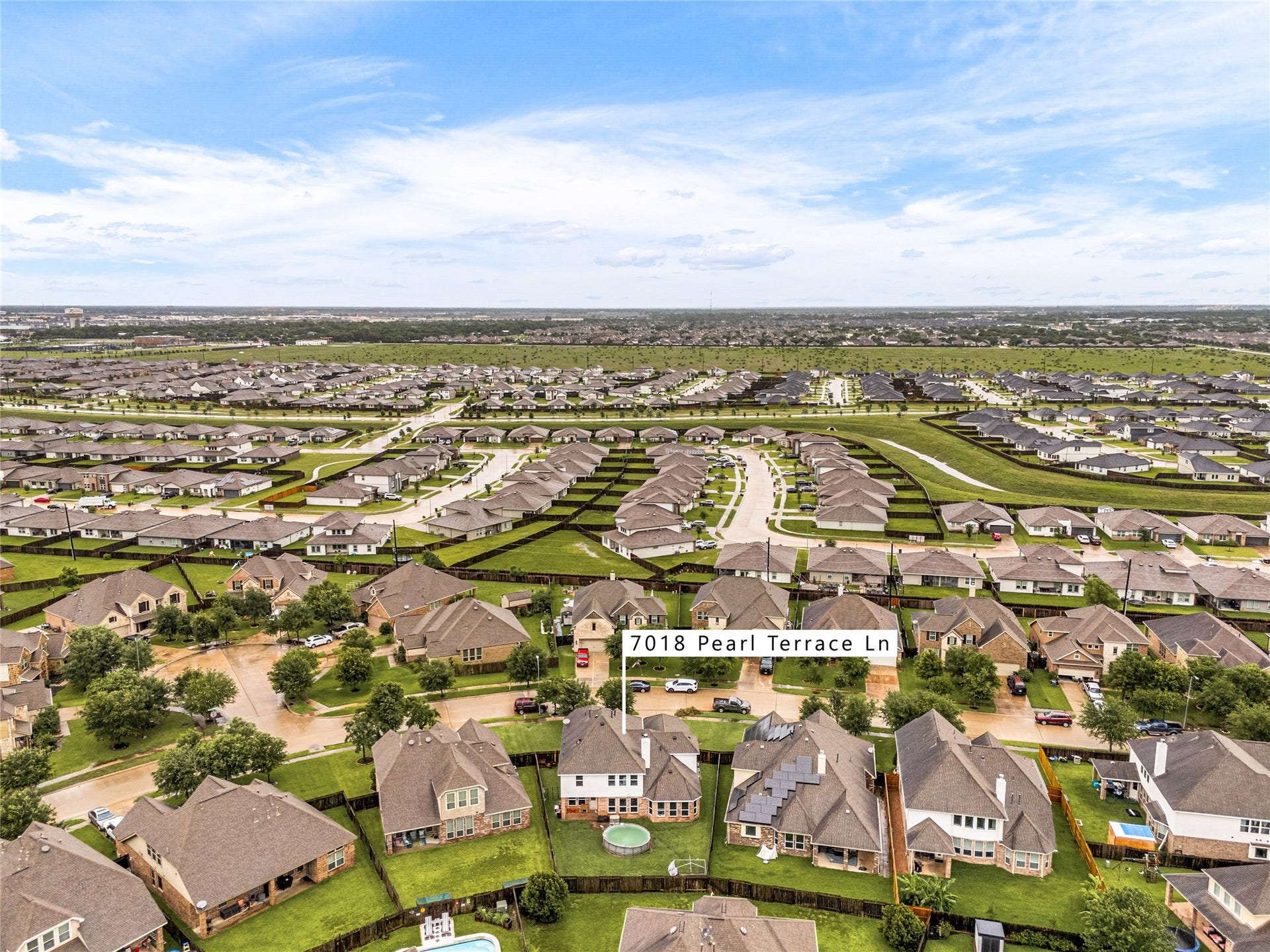 7018 Pearl Terrace Lane, Richmond, TX 77469 Sweeping aerial view of the established Walnut Creek community, tree-lined streets, well-kept homes, and open green space stretching to the horizon, all just minutes from nearby shopping and amenities.