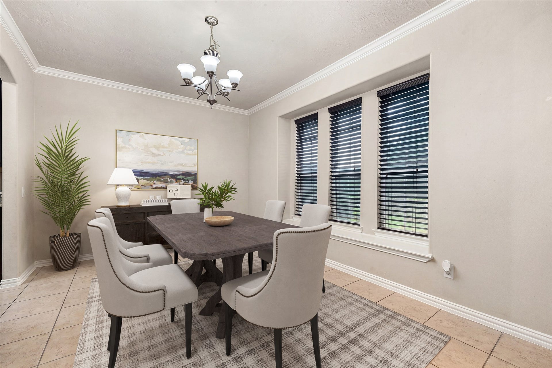 7018 Pearl Terrace Lane, Richmond, TX 77469 Elegant formal dining room featuring crown molding, tile flooring, an oversized window for natural light, and a classic chandelier, ideal for gatherings and entertaining. *Virtually Staged
