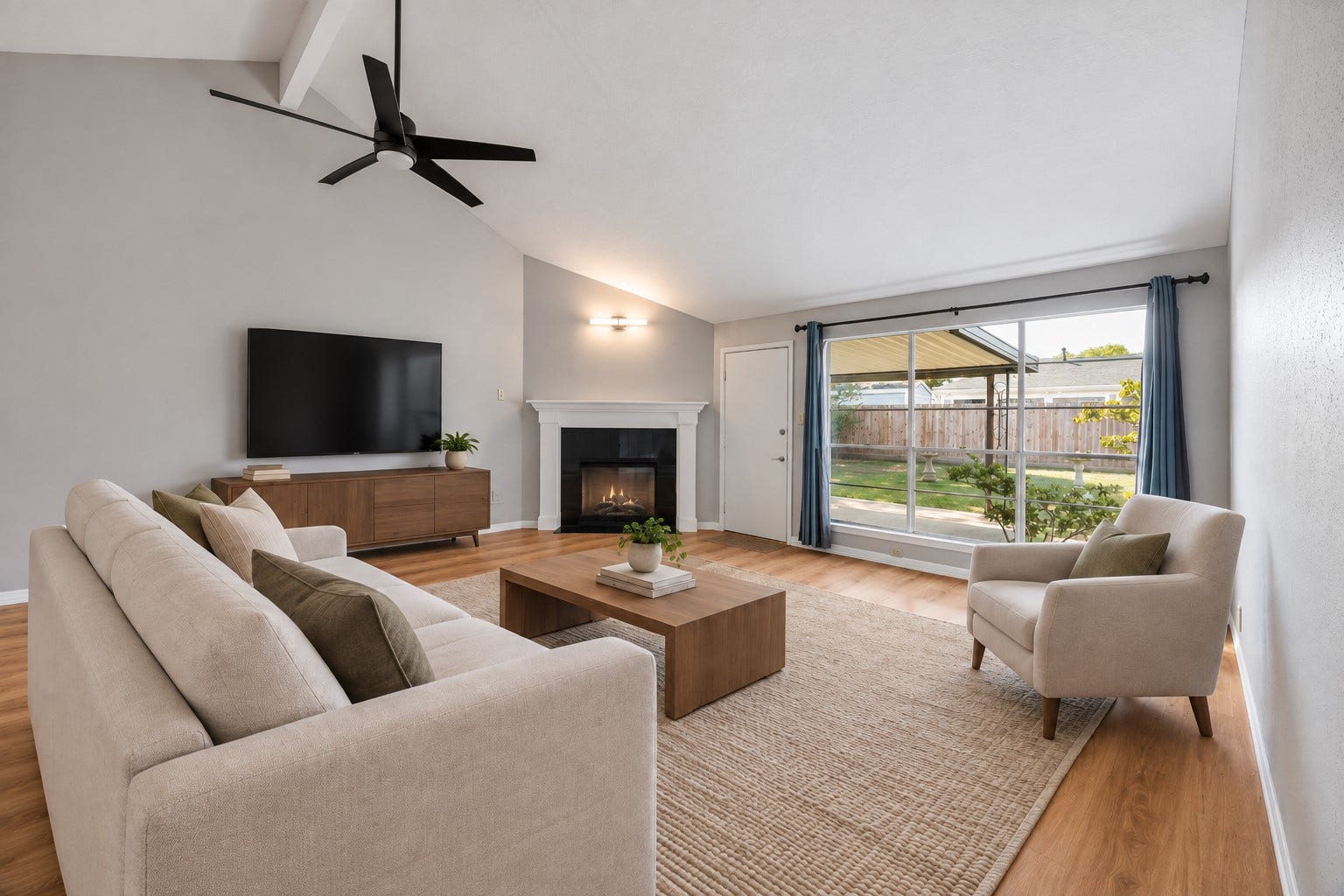 16911 Summer Dawn Place, Houston, TX 77095 Expansive backyard-facing windows bring the outdoors into the living room, while the vaulted ceiling gives the seating area an open, airy feel.