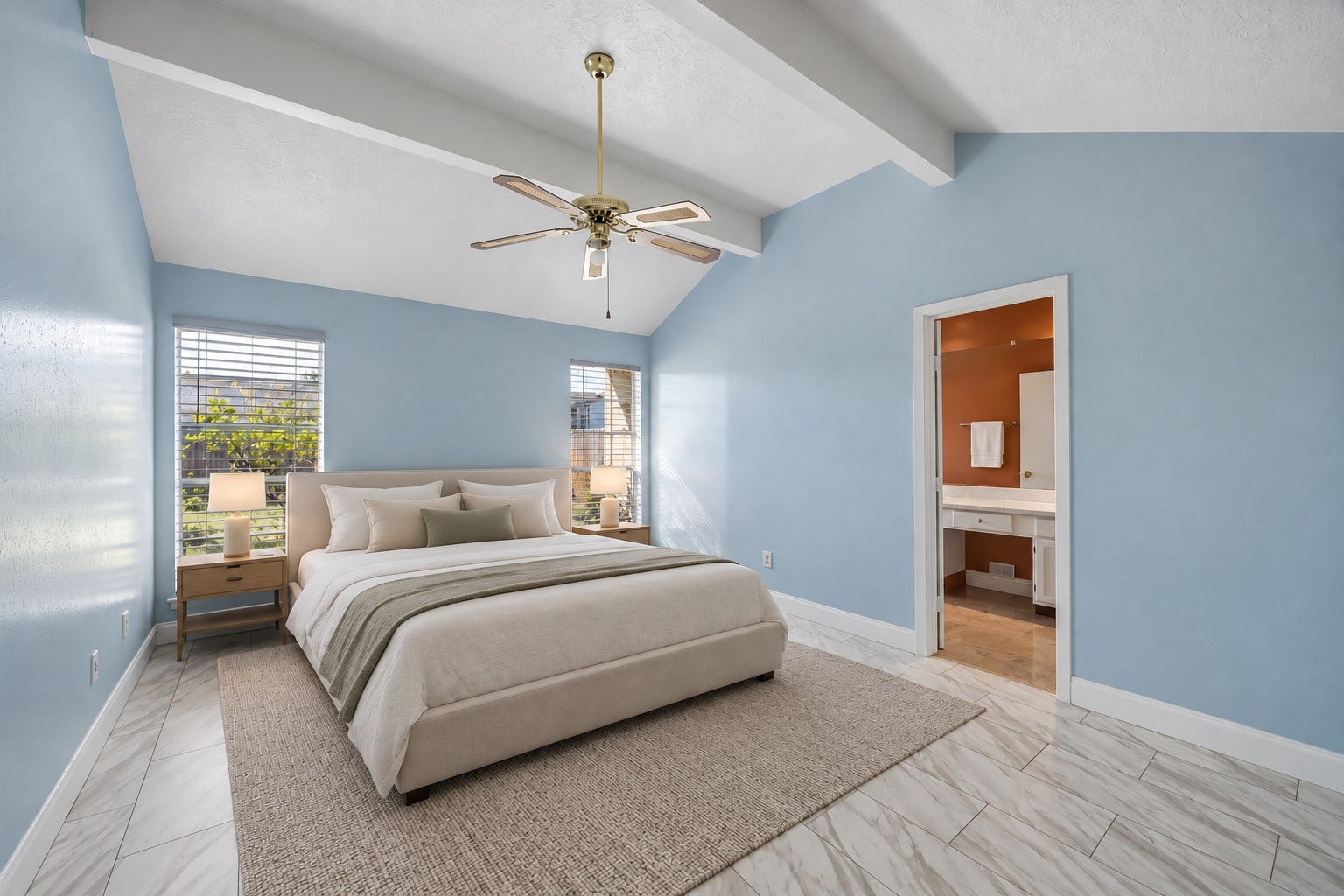 16911 Summer Dawn Place, Houston, TX 77095 Shaw vinyl plank flooring, installed in 2020, runs through the primary bedroom beneath the dramatic vaulted ceiling. Windows on two walls bring in additional daylight.