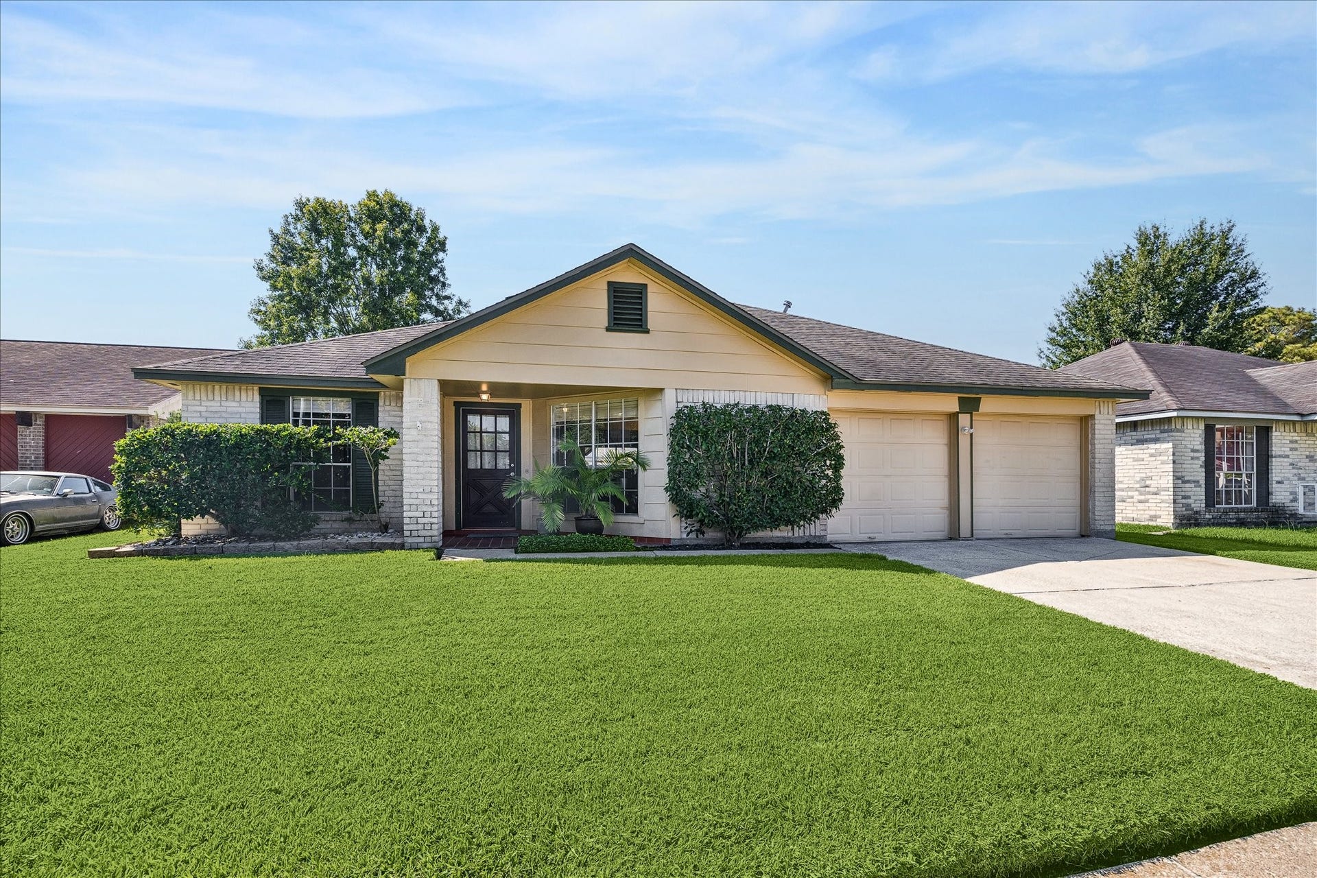 16911 Summer Dawn Place, Houston, TX 77095 Alternate curb view highlights the homes classic single-story profile, brick-and-siding exterior, wide driveway, and neatly maintained landscaping.