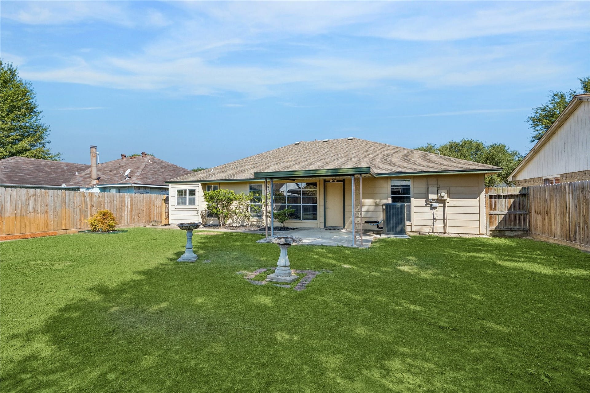 16911 Summer Dawn Place, Houston, TX 77095 Another backyard angle shows the depth of the 6,300 SF lot and the separation between the home, covered patio, and open lawn.