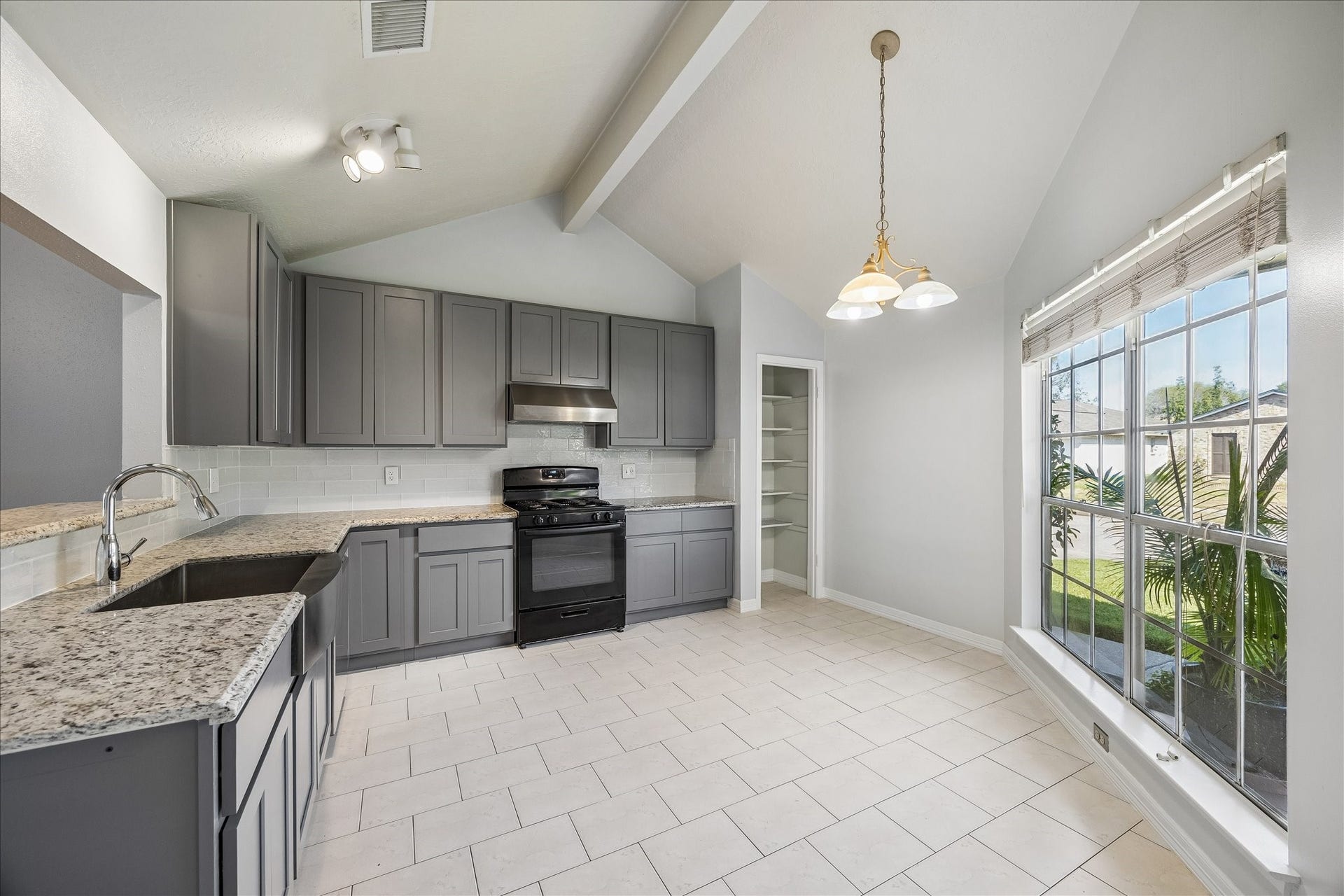 16911 Summer Dawn Place, Houston, TX 77095 Remodeled kitchen features granite countertops, updated millwork cabinetry, stainless appliances, a vented range hood, and tile flooring. Large windows brighten the adjoining breakfast area.