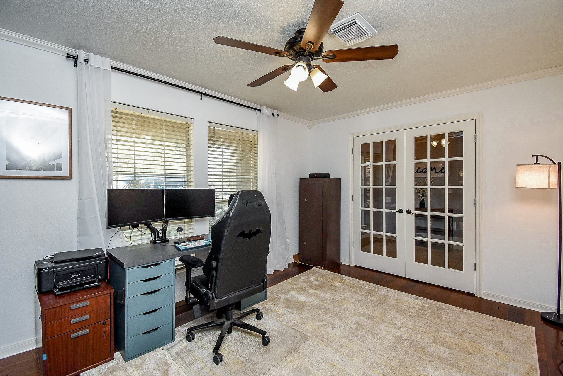6703 Morning Glory Trace, Richmond, TX 77407 Bright home office with large windows, French doors, and ceiling fan, ideal for productivity in a comfortable setting.