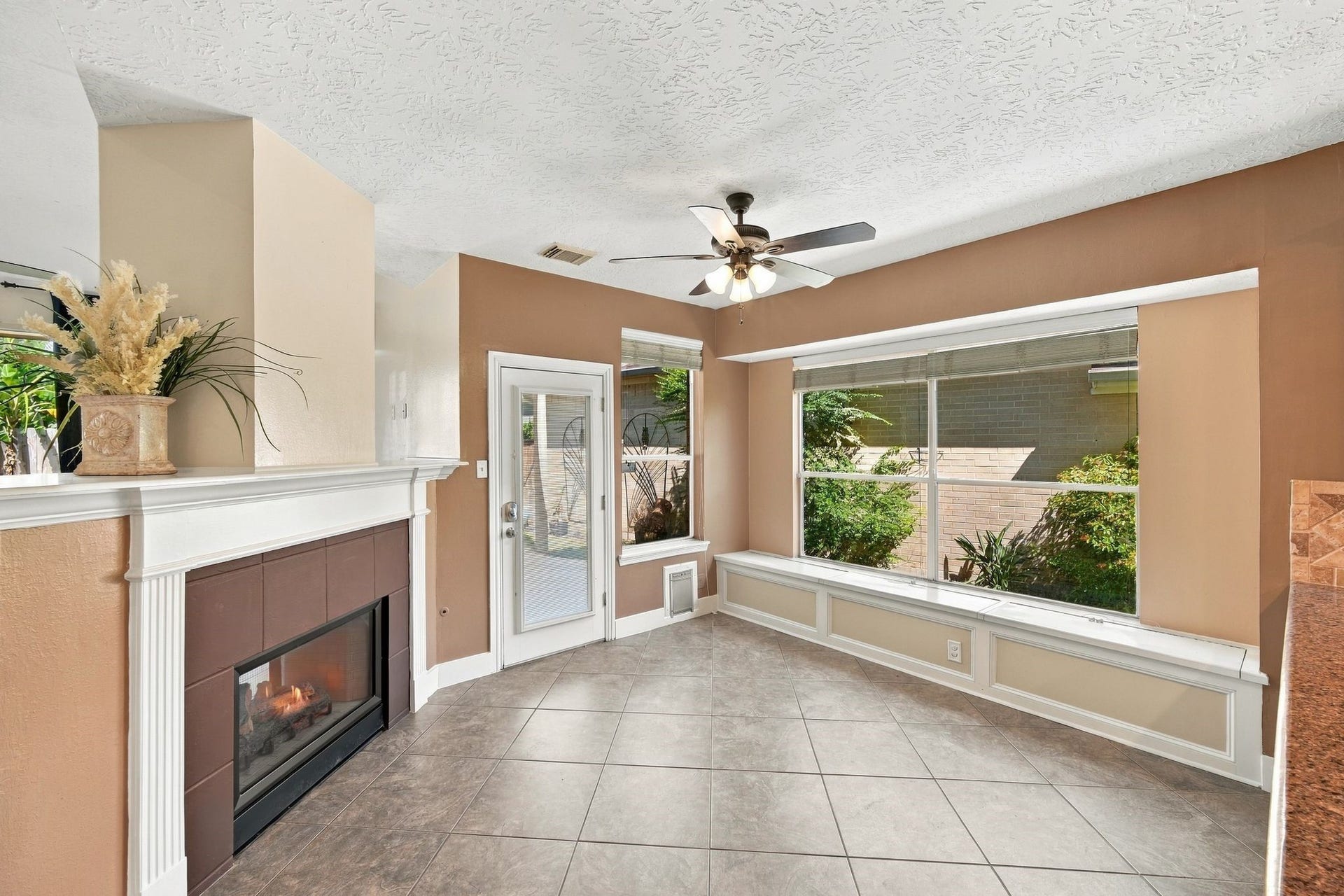 201 Lago Vista Street, League City, TX 77565 Experience the inviting charm of this bright and airy living space, featuring a cozy fireplace, elegant tile flooring, and abundant natural light streaming through large windows, perfect for creating your dream home.