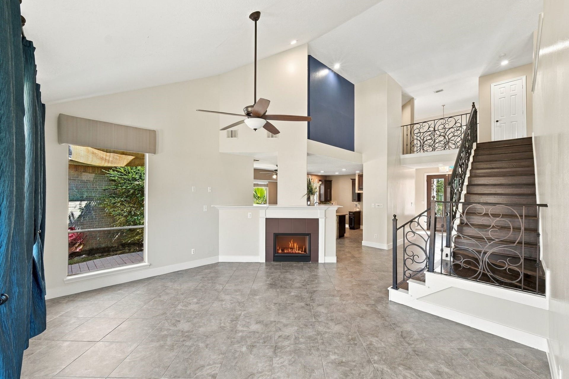 201 Lago Vista Street, League City, TX 77565 Gather around the inviting fireplace in this elegant living space, perfect for cozy evenings and creating lasting memories.