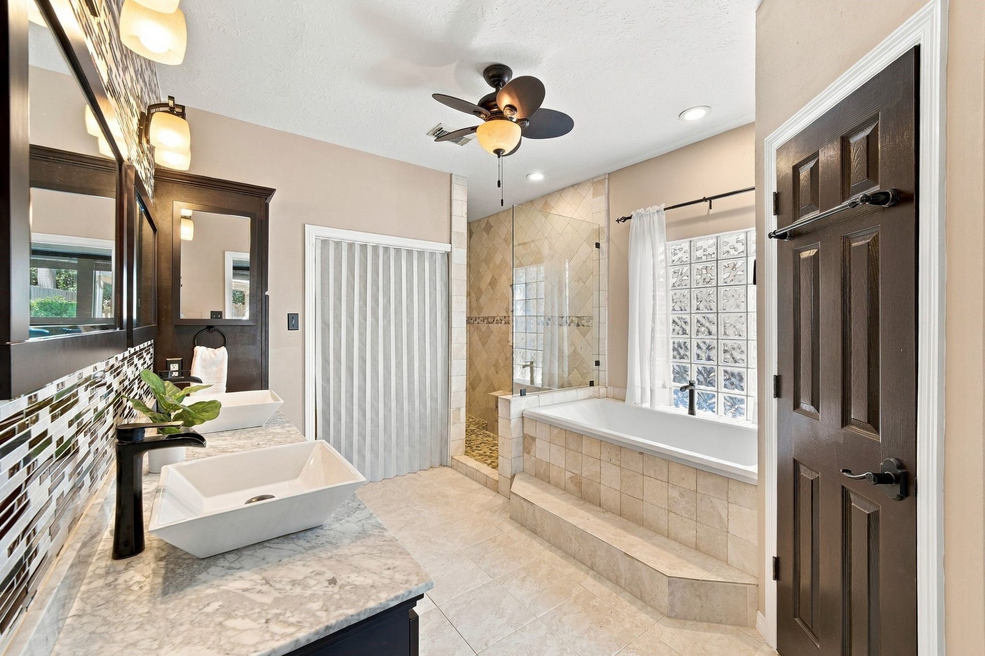 201 Lago Vista Street, League City, TX 77565 Unwind in a luxurious bathroom oasis, featuring a spacious tub perfect for relaxing after a long day.