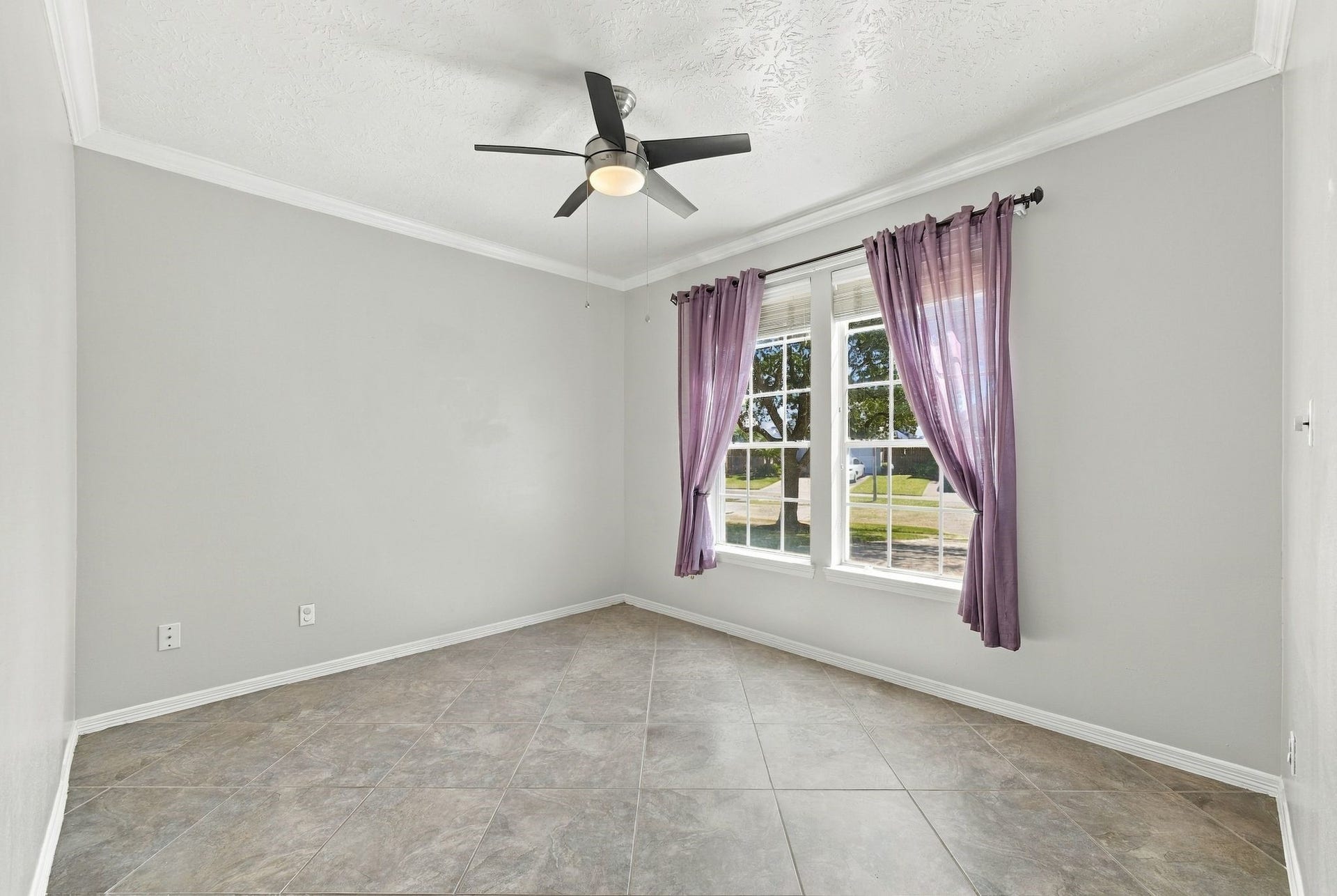 201 Lago Vista Street, League City, TX 77565 Bright and inviting, the first-floor room offers an ideal space for a home office or study, featuring ample natural light and sleek tiled flooring.