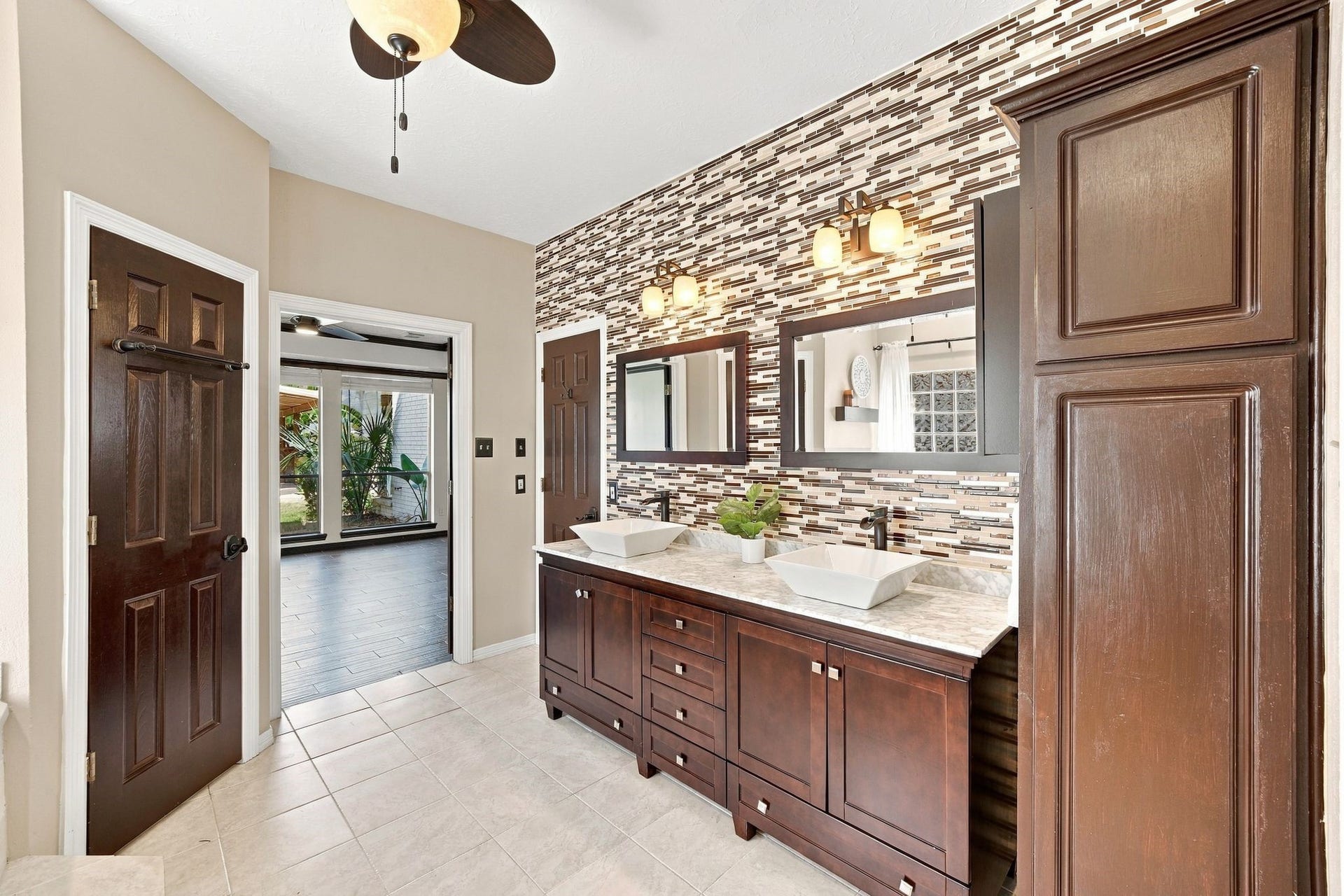 201 Lago Vista Street, League City, TX 77565 Experience luxury in the primary bathroom with elegant double sinks and abundant storage, perfect for a seamless morning routine.