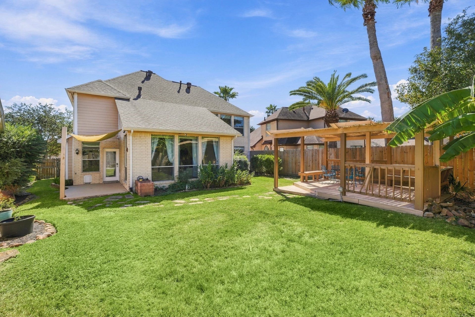 201 Lago Vista Street, League City, TX 77565 Expansive backyard with a spacious pergola offers endless opportunities for family fun and relaxation.