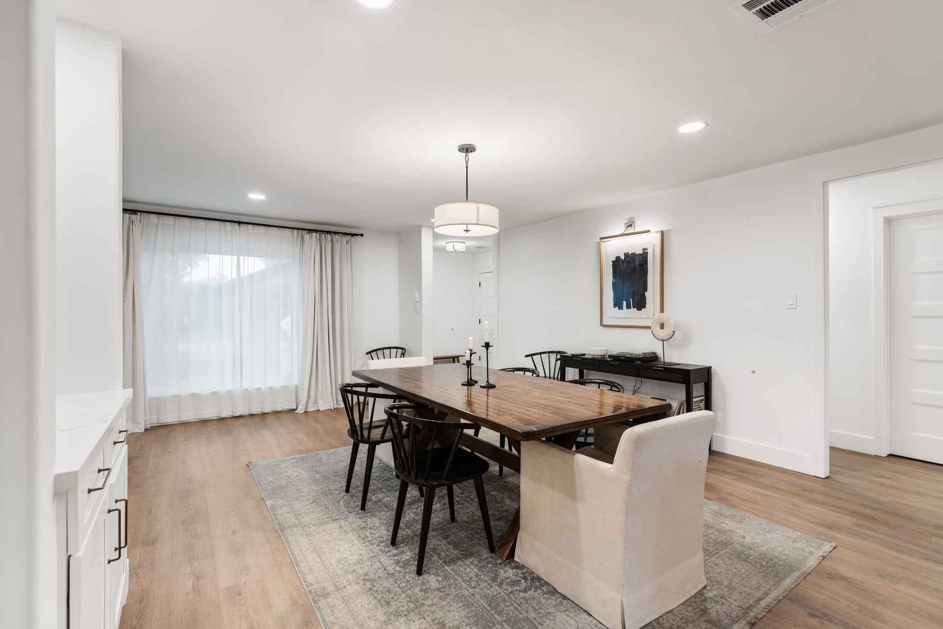 9206 Kapri Lane, Houston, TX 77025 Generously sized dining space offers abundant natural light, updated flooring, recessed lighting and a statement ceiling fixture, with easy access to the surrounding living spaces.