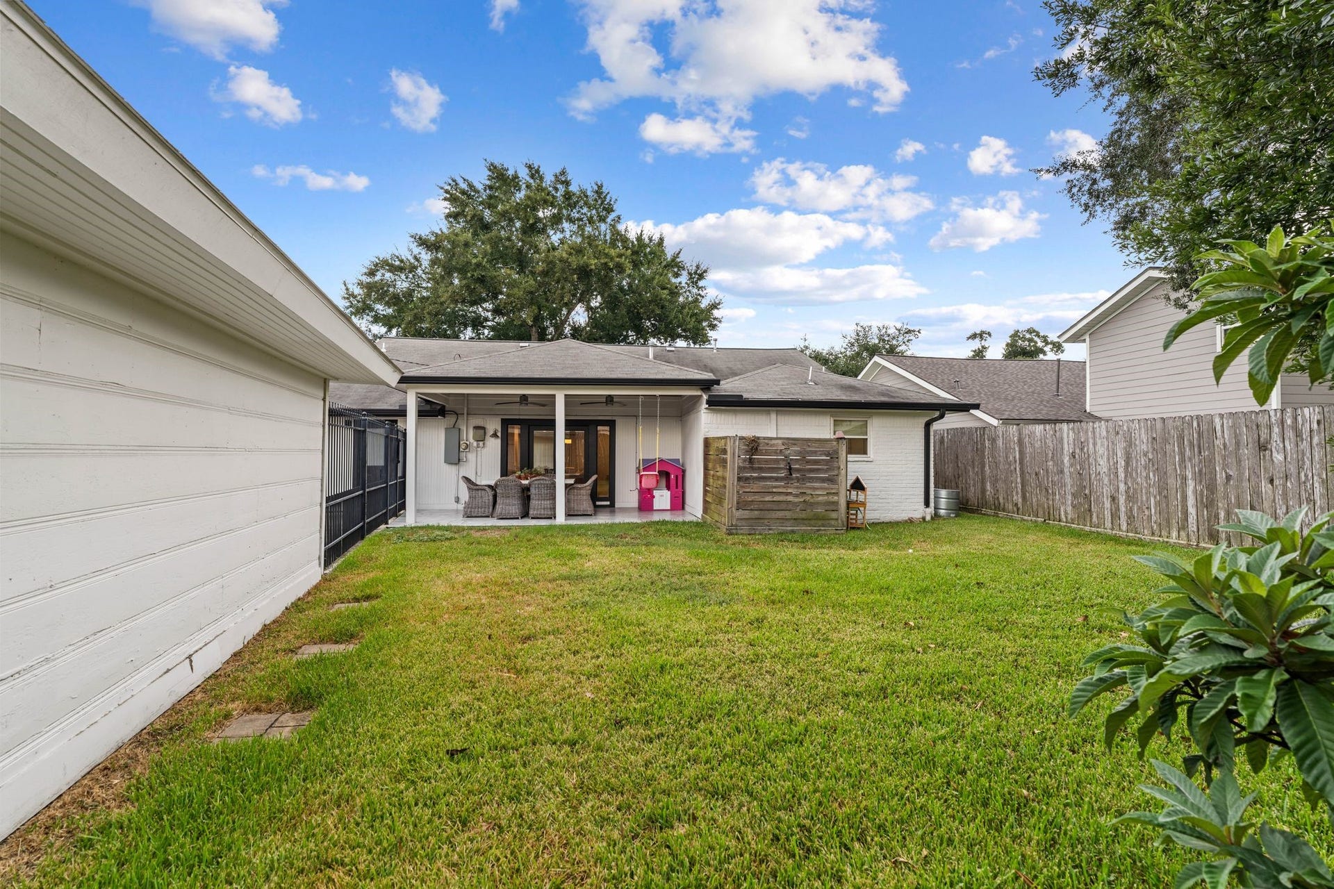 9206 Kapri Lane, Houston, TX 77025 Spacious fenced backyard provides plenty of usable lawn and leads directly to the covered patio, creating an easy extension of the homes indoor living space.