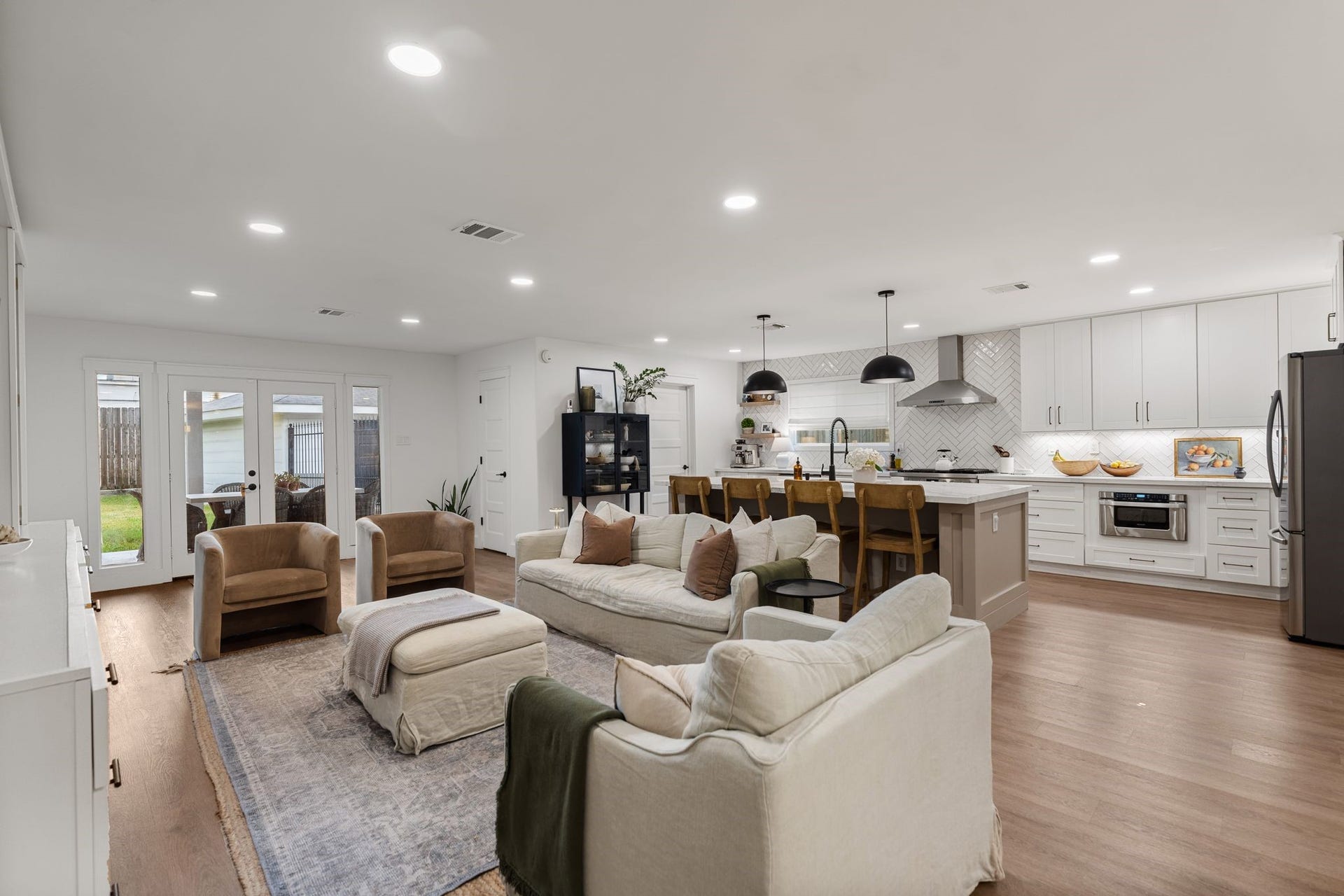 9206 Kapri Lane, Houston, TX 77025 The open living area flows seamlessly into the kitchen, enhanced by a large island that defines the heart of the home and a French door escape to the backyard