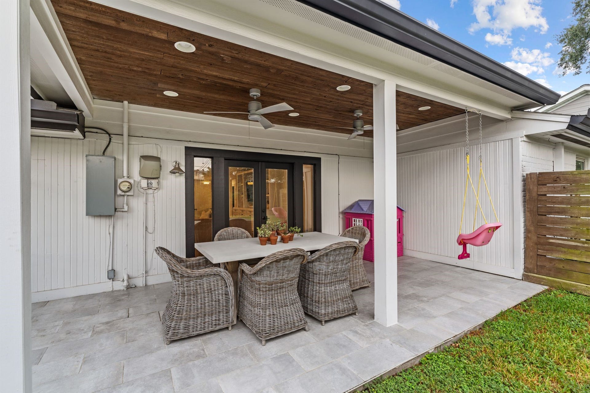 9206 Kapri Lane, Houston, TX 77025 Inviting covered patio features tiled flooring, a warm wood-plank ceiling, recessed lighting, dual ceiling fans and French doors connecting the outdoor space to the interior.