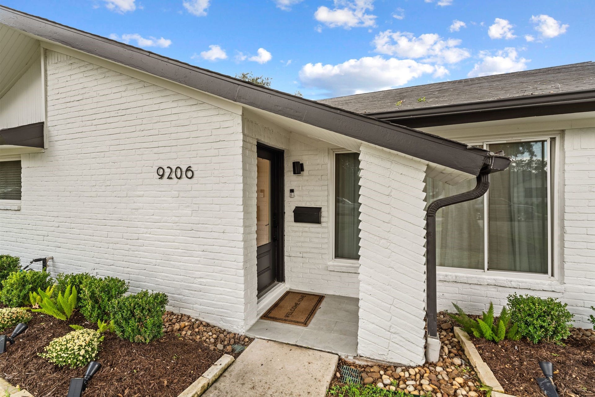 9206 Kapri Lane, Houston, TX 77025 Welcoming covered entry features painted brick, contemporary exterior lighting, established landscaping and architectural details that add character to the homes faade.