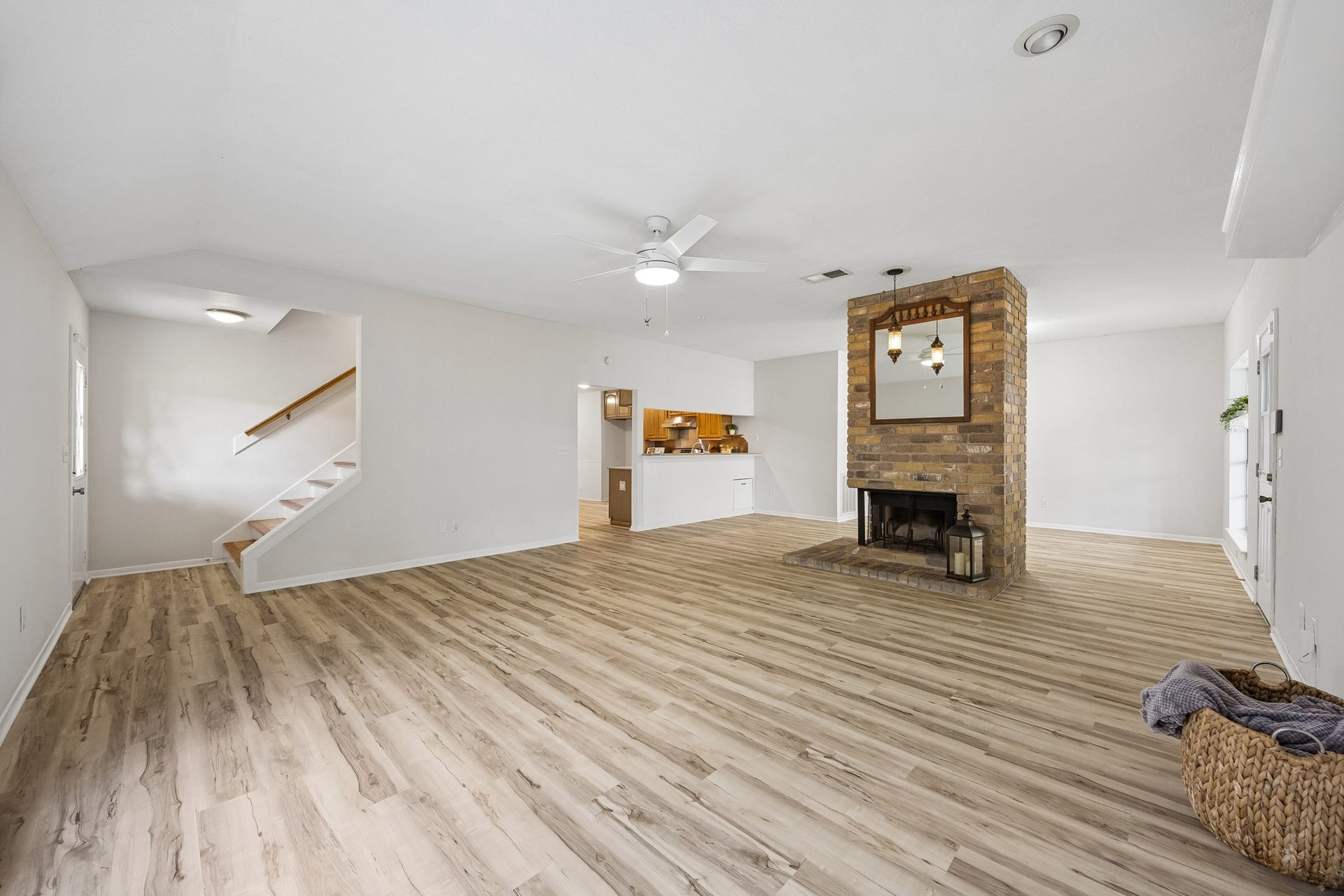 2716 Village Mills Drive, Pearland, TX 77584 Spacious family room with updated flooring and fireplace.