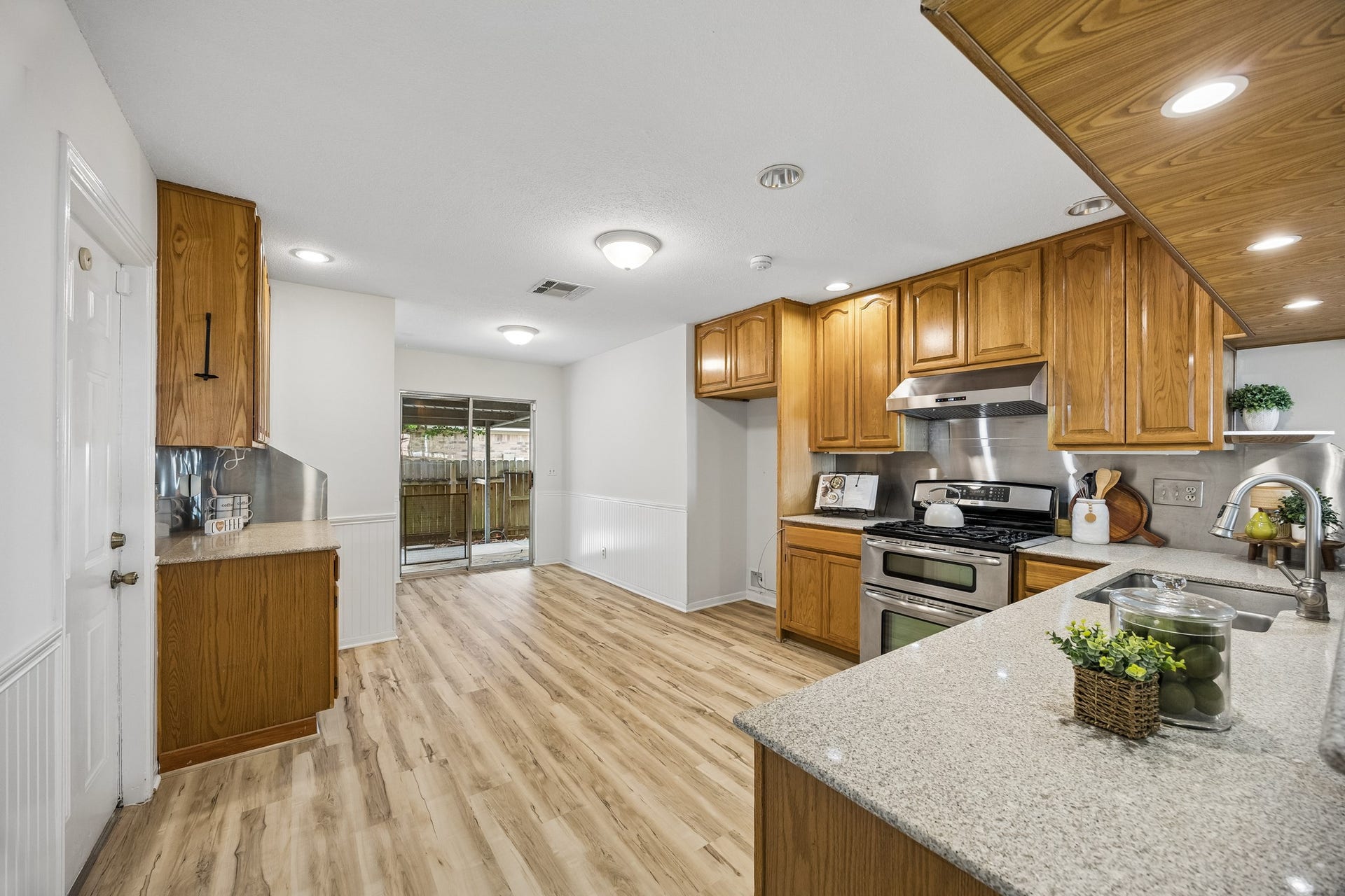 2716 Village Mills Drive, Pearland, TX 77584 Plentiful cabinetry in this updated kitchen with corian counters, updated appliances, breakfast area overlooks pation.